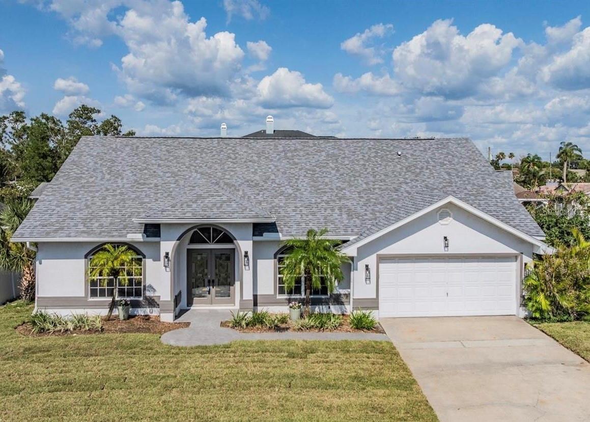Waterfront home in Dunedin! This home features 3 bedrooms, 2 full bathrooms, a 2-car garage, a composite wood deck/dock, and a boat lift. For boaters, the home sits on a deep water canal with direct Gulf access. The home is light & bright, has an open floorplan, vaulted ceiligs, split bedrooms, and water views! The kitchen is newly renovated and features wood cabinets, granite countertops and stainless-steel appliances. There is eat-in space in the kitchen as well as a separate dining room. The master suite features a large walk-in closet, a fireplace, private bath & sliders overlooking the water. The master bathroom has dual vanities, a Jacuzzi tub, walk-in shower & private toilet. The guest bedroom also has a walk-in closet & sliders with a canal view. The open indoor plan & outdoor deck areas make this home great for entertaining! This property is a boater's dream. Take a short boat ride to Caladesi State Park for lunch or go fishing in the Gulf of Mexico. On land, stroll along the causeway, ride your bike on the Pinellas Trail, play golf at the local club, or enjoy the unique shops, top rated restaurants & countless downtown activities... there's plenty to do in Dunedin! Centrally located to major thoroughfares, downtown Dunedin, the Dunedin Causeway and more! This is a MUST SEE for boating enthusiasts or buyers seeking a waterfront home!