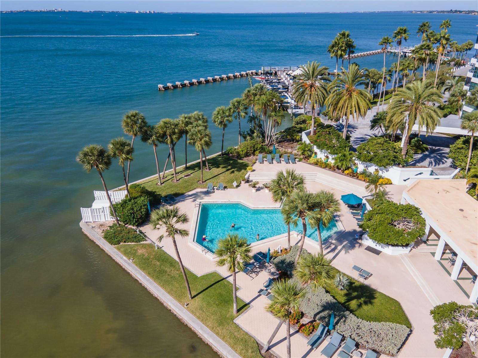 Step into the most luxurious waterfront condo that awaits you in this stunning two bedroom, two-bath condo in the heart of Sarasota! Enjoy breathtaking views of the Bay of Sarasota and The Gulf of America from one of two of your private balconies. This stunning 100% completely renovated 5 stack VanGogh located on the 17th floor will leave you breathless. You will not believe your eyes when you see the attention to detail built into this stunning condo. Floor to ceiling mirrors in entryway accentuate the grand view as you enter the condo. Seller did a complete demolition of all interior drywall, ceiling tiles, all interior AC ductwork, plumbing, flooring and electrical. Installed all new plumbing, electrical, AC ductwork and / outdoor lighting. All new indoor lighting design and hardware throughout. The gorgeous all new wood flooring is in main areas and bedrooms, with all new tile in the bathrooms and patios. Raised the ceilings for maximum grand feeling and the stunning views. Both bathrooms completely remodeled with top of the line marble, quartz and waterworks hardware. Extended the width of the hall to open up laundry area with a stackable washer and dryer as well as a tankless water heater. Installed all new hurricane doors at both patios. Custom doors and hardware throughout. Brand new cabinetry along with custom closet cabinetry in primary suite. Installation of a completely new and hard wired AV system for Sound, TV, lighting & shades for the entire house. Hard wired the WiFi Sonos system through out the entire condo. And wait until you see this extraordinary kitchen, it is a culinary dream… brand new top of the line Fulgor Italian appliances! Waterfall quartz island countertop and quartz backsplash. Full size counter depth refrigerator, wine cellar, and 2 freezers. Microwave, convection combo, built in coffee maker, induction range top, oven & dishwasher. Smart home features include Ring and Nest. When you are ready to retire for the evening you simply use the remote powered shade system by Creston for all windows. Entry into 888 Boulevard of the Arts has a 24 hour guarded gate station. Just steps outside the condo you will find access to kayaks and/or boats. You can also enjoy the resort style heated pool along with pickleball, tennis courts and fitness room. Assigned underground parking (this unit has the best spot in the building) as well as 2 EV charging stations up on the top deck. You are close to all the key spots that beautiful Sarasota has to offer: Lido Beach, Siesta Key, Anna Maria Island, Long Boat Key and St Armands Circle. Sarasota offers exquisite restaurants, shopping, theaters and many cultural activities including Asolo Theater, Van Wezel Performing Arts Center and John Ringling Museum. You don’t want to miss this extraordinary condo with the most precise attention to detail at every turn. This unit is truly perfection.