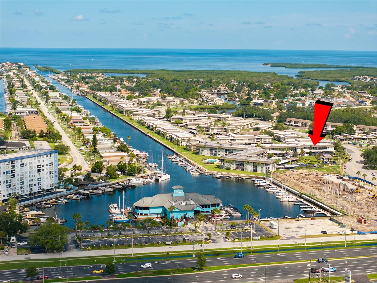 Waterfront Community Living! Welcome to your beautifully maintained 2-bedroom, 2-bath condo located in a peaceful waterfront community! This second-floor unit comes partially furnished for your convenience and features a newer air conditioning system, ensuring year-round comfort. Step inside to find a spacious eat-in kitchen—perfect for meal prepping or casual dining. The open floor plan seamlessly connects the kitchen to the dining and living areas, creating a warm, inviting space ideal for both entertaining and relaxing. An enclosed back porch provides the perfect spot to sip your morning coffee or unwind with your favorite book. The primary bedroom offers a generous walk-in closet and a private ensuite bathroom complete with a walk-in shower. The second bedroom is ideal for guests, a home office, or additional living space. Enjoy resort-style amenities including a private community pool overlooking the water and a community boat dock—a dream for any boating or water enthusiast. The monthly fee includes: Cable & Internet, Community Pool & Dock Maintenance, Exterior & Grounds Maintenance, Common Area, Sewer, Water & Trash Services. Optional membership to Gulf Harbors Beach Club is available granting access to a private beach retreat just minutes away! Located only 2 miles from historic downtown New Port Richey, you’ll have easy access to charming shops, local restaurants, and entertainment. Plus, you're just 33 miles from Tampa International Airport and 35 miles from downtown St. Petersburg, making travel a breeze. Whether you're looking for your year-round residence or the perfect winter getaway, this condo has everything you need. Schedule your private showing today!