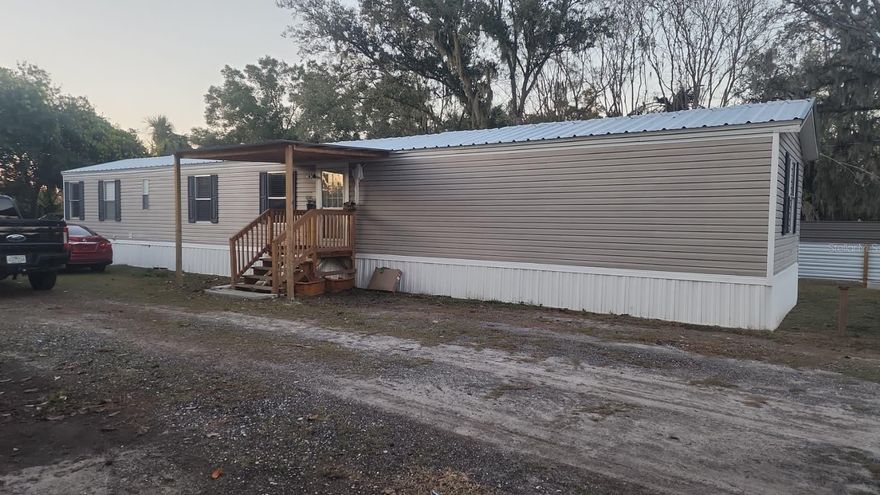 ONLY CASH. Financing is not accepted—cash only—because the mobile home has been moved from its original location. Discover this incredible opportunity! This property sits on 0.26 acres of privately owned land and features a 2005 manufactured home, fully renovated and move-in ready. It offers the space and peace you’re looking for, combined with modern upgrades and a fresh, stylish design. The home includes a brand- new 2025 AC, 2025 septic tank, 2025 well, and a metal roof, providing durability and efficiency for years to come. Inside, you’ll find a completely updated interior with a modern kitchen, renovated bathrooms, updated flooring, and a clean, contemporary look. The home offers 3 bedrooms, 2 bathrooms, a laundry area, and a comfortable, functional layout. Need outdoor space? You’ve got it. The large lot provides plenty of room to park boats, trucks, large vehicles, and even includes water and sewer hookups for an RV—perfect for guests, extra income, or personal convenience. Conveniently located with easy access to major interstates, schools, and shopping centers, this property brings together location, value, and modern living. Don’t miss the chance to own this beautifully updated home!