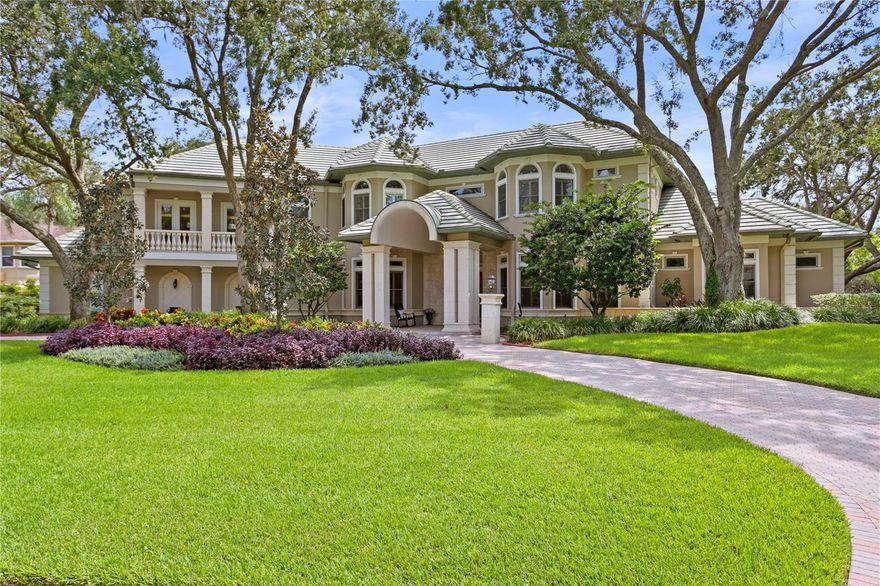 This beautiful home located in the guard gated, golf and country club community of Avila is nestled on a 1 acre homesite with sweeping water front views. Designed with meticulous attention to detail by Alvarez Homes, this custom-built home spans 6,357 square feet of air-conditioned living space. This residence features a luxurious Downstairs Master Suite, an additional 3 Bedrooms, 4 Full and 2 Half  Bathrooms, a Home Office, a Movie Room, and a Screened-in Pool and Lanai. Upon arrival, the attention to detail is evident in the beautifully landscaped grounds, the circular driveway, and the grand double front entry doors that warmly greet you and your guests. The formal living and dining areas are thoughtfully designed for entertaining, highlighted by elegant columns, crown molding, wood flooring, and intricate millwork. The gourmet kitchen has been updated with professional grade appliances including an induction cook top, Wood Mode Cabinetry, Quartzite countertops, a breakfast bar and a kitchen dining room. The adjoining family room includes a fireplace, wet bar with beverage refrigerator and has French doors which open to your stunning screened in pool and lanai. The master suite on the main level is a sanctuary in itself, graced with new wood flooring, a fireplace, a cozy sitting area, and a master bathroom recently adorned with exquisite finishes. French doors open to reveal the breathtaking screened-in pool and lanai, seamlessly connecting indoor and outdoor living spaces.
The outdoor living area is a haven of relaxation, complete with a brand-new outdoor kitchen. The screened-in patio offers multiple seating areas to bask in the vibrant Florida sunshine. Come home to this gorgeous estate in Avila where you will find a lifestyle, security and privacy that is the best in Tampa Bay!