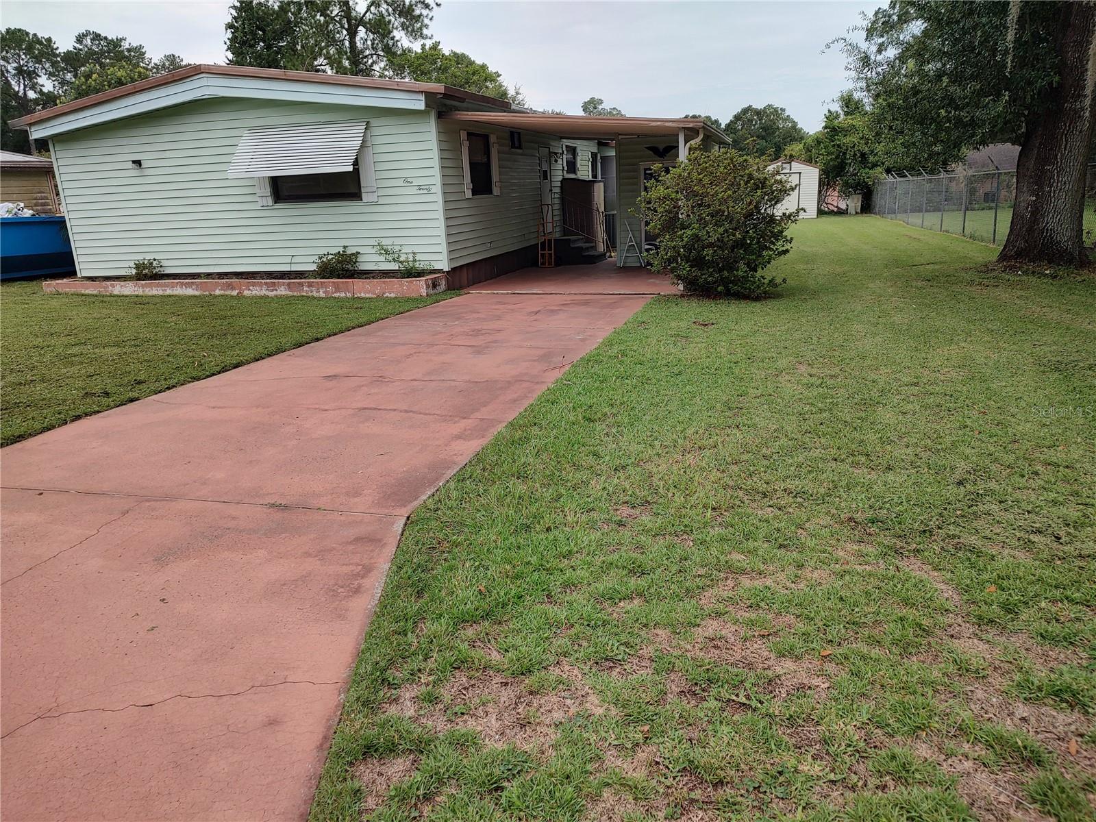 GREAT LOCATION, GREAT SQUARE FOOTAGE PLUS WORKSHOP WITH ALL THE GOODIES ALL ON A ¼ ACRE LOT!! 3 BDRM 2 BATH SPLIT PLAN HOME THAT IS BEING SOLD FURNISHED INCLUDING A FULLY STOCKED WORKSHOP…PERFECT FOR SNOWBIRDS. LOCATED ACROSS FROM THE CLUBHOUSE YOU WILL BE STEPS AWAY FROM THE COMMUNITY POOL, SHUFFLEBOARD, LIBRARY, FITNESS ROOM AND MEETING ROOM WHERE THE FREQUENT POTLUCKS ARE HELD!! HOME FEATURES A MASSIVE LIVING ROOM, KITCHEN WITH CENTER ISLAND AND DINING AREA AND INSIDE LAUNDRY INCLUDING WASHER AND DRYER. ATTRACTIVE EASY CARE FLOORING IN MOST OF THE HOME SO YOU JUST SWEEP, DAMP MOP AND GO!! 2 GUEST BDRMS HAVE CARPET, CEILING FANS AND WALK IN CLOSETS. THE PRIMARY BDRM IS SPACIOUS AND HAS A REMODELED BATH WITH DOUBLE SINKS, LINEN CLOSET AND STEP IN SHOWER. COVERED PORCH ON ONE SIDE OF THE HOME AND SCREEN ENCLOSED ROOM ON THE OTHER SIDE…EITHER ONE PERFECT FOR MORNING COFFEE OR EVENING DRINK. COMMUNITY IS CLOSE TO DINING, SHOPPING, WALMART, AND MEDICAL PLUS SILVER SPRINGS ATTRACTION AND ALL THE BOATING, FISHING, HIKING AND HUNTING THAT THE NEARBY OCALA NATIONAL FOREST HAS TO OFFER. THE BEST OF BOTH WORLDS WITH CITY CONVENIENCES AND EASY ACCESS TO NATURE. BEST OF ALL YOU OWN THE LAND AND THE HOA FEE INCLUDES ALL THE AMMENITIES PLUS WATER, TRASH AND SEWER!! MAKE THIS YOUR FULL TIME OR WINTER RESIDENCE TODAY!