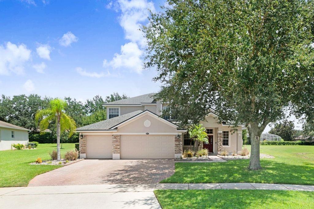 Where memories are made, this home celebrates 4 Bedrooms / 4.5 Bath, HUGE LOT, Sparkling POOL and 3 CAR GARAGE, Located in a desirable GATED/GUARD 24/7 Community - Legends Country Club. ROOF was replaced (June 2019). Residence PRIMARY SUITE is conveniently situated on the FIRST FLOOR, with California walk-in closet and spa-inspired master bath – featuring dual sinks and striking Roman Jacuzzi tub, with elegant columns. Step into the heart of the home, where the gourmet kitchen boasts GRANITE countertops, a middle island, double oven, abundant counter space and cabinetry – sure to please the family chef! French doors and warm wood floors enhance the homes inviting character. Step outside into your own private oasis with a beautiful CURVED POOL, complete with a WATERFALL, covered lanai – perfect for leisure or entertaining in style. *** LEGENDS HOA DUES INCLUDE (high-speed internet and TV Cable) PLUS Residents benefit from exclusive amenities including 24/7 GUARD and 2 Entry GATES, a COMMUNITY POOL, Kiddie Pool, Hot Tub, Sauna, FITNESS CENTER, Tennis/Pickleball and basketball courts, Tavern/Grille, Golf Pro Shop, Pool Table/Ping Pong, Community Kitchen and 10,000+sq ft. CLUBHOUSE that overlooks Lake Louisa! Prime location just minutes from Hwy 27, Hwy 50, FL Turnpike, putting dining, shopping, hospitals, schools within easy reach. Also, you’re only a short drive to Disney World and all the Orlando attractions. This property combines timeless elegance with comfort and style, making it an exceptional place to call home.