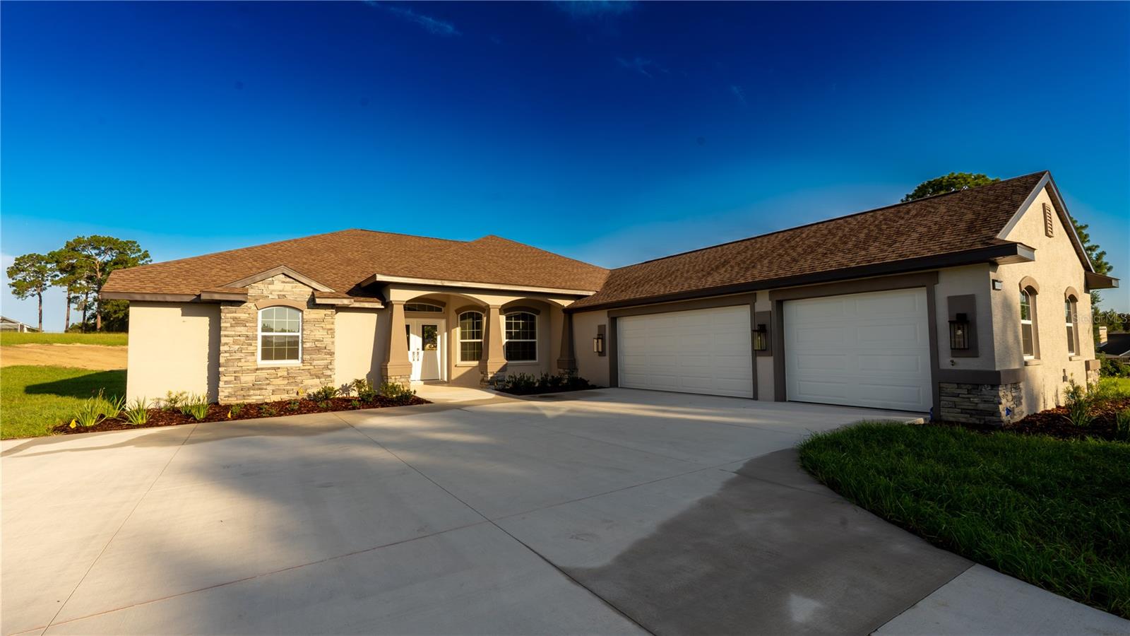 Experience Modern Florida Living at Its Finest!
This 2025 Sweetwater Homes of Citrus Tradewinds model is a masterpiece of craftsmanship and design, offering 2,067 sq. ft. of refined living space on 1.09 acres of picturesque land with breathtaking views. Featuring 3 bedrooms, 2 bathrooms, and a spacious side-entry 3-car garage (est. 945 sq. ft.), this home blends elegance with functionality.
Inside, you’ll find beautiful neutral-tone flooring and paint, soaring 10’ ceilings, and designer fixtures throughout, creating a bright and airy atmosphere. The open-concept floor plan, filled with abundant natural light, flows seamlessly into every space, perfect for entertaining or relaxing.
Set on over an acre, the property offers plenty of room for outdoor living spaces or a pool, all while enjoying serene, unobstructed views. Never lived in and thoughtfully customized, this home is ready to impress. Don't miss the opportunity to call this beauty your home.