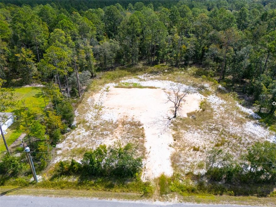 This beautifully prepared property is ready for your dream home! The lot has been fully cleared and root raked, with an elevated and compacted house pad and driveway already in place. A culvert has been installed, the well is complete, and 40 additional loads of fill have been brought in and spread for optimal elevation. Power is conveniently located at the corner of the lot, and a survey is available upon request. Engineer-stamped house plans for a 1,800 sq. ft. ranch-style home with an attached garage are also available upon request. High-speed Xfinity/Comcast Internet is reportedly available. With just a septic system and your home build remaining, you’re steps away from enjoying peaceful sunsets on the porch, overlooking the grove with the one you love. The lot to the left may also be available. Call for more details!