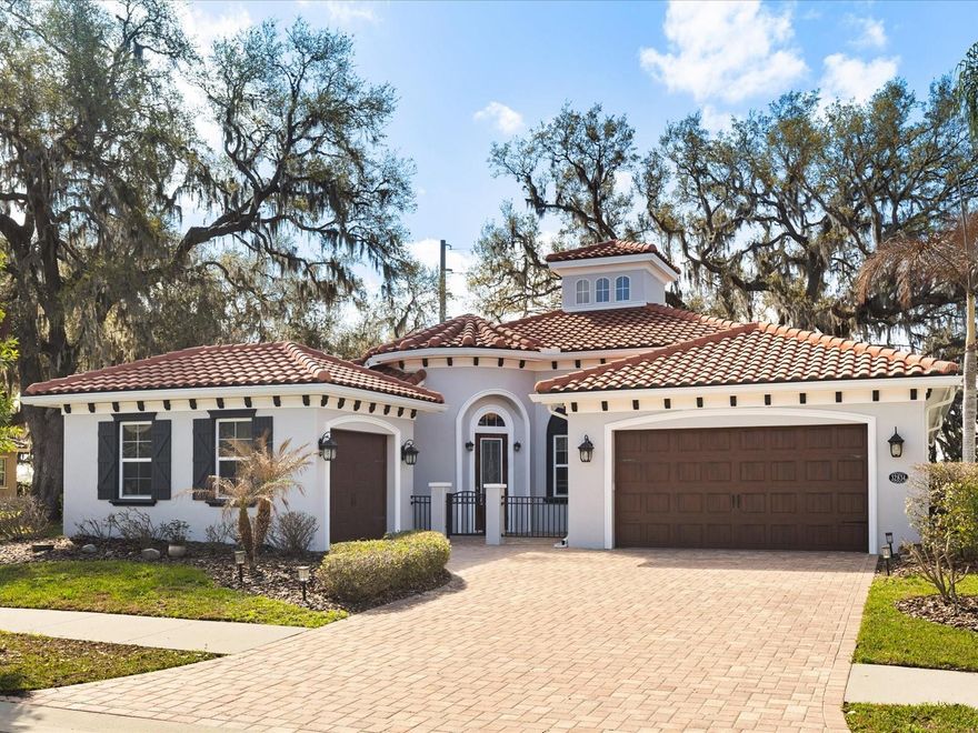 Experience luxury living in this custom-built, single-story executive estate, ideally situated on a quiet gated cul-de-sac in the prestigious Gardens of Watergrass. Thoughtfully upgraded throughout, the home greets you with a pavered driveway, gated courtyard, and an impressive soon-to-be-installed Brazilian hardwood front door. Inside, new Hickory engineered hardwood floors, double-tray ceilings, and detailed crown molding and finish work creates an atmosphere of timeless elegance. The open-concept great room, complete with integrated surround sound, flows into a gourmet kitchen featuring new luxury cabinetry, new quartz countertops, new stainless steel appliances, a large island, custom tile work, and a beautifully crafted walk-in pantry. With 4 bedrooms, including a flexible office or den option, and 3 full baths, the floor plan offers both versatility and sophistication. The owner’s retreat provides a serene escape with dual vanities, a garden tub, a dual-head walk-in shower, and new custom built-out closet system. Impact-rated Anderson sliders (to be installed) open to a newly screened private outdoor haven with a spacious covered lanai shaded by mature trees, ideal for relaxing or entertaining. Additional upgrades include a newer HVAC system, new water heater, custom window treatments, enhanced electrical and lighting features, epoxy garage flooring, and updated exterior finishes. The golf-cart friendly Watergrass community offers exceptional amenities: a resort-style zero-entry pool, splash zone, Jr. Olympic pool, fitness center, clubhouse, tennis and basketball courts, dog parks, and multiple playgrounds. Close to premier shopping, dining, medical facilities, top-rated schools, and major commuter routes, this estate blends luxury, privacy, and convenience in one of Wesley Chapel’s most desirable gated neighborhoods.