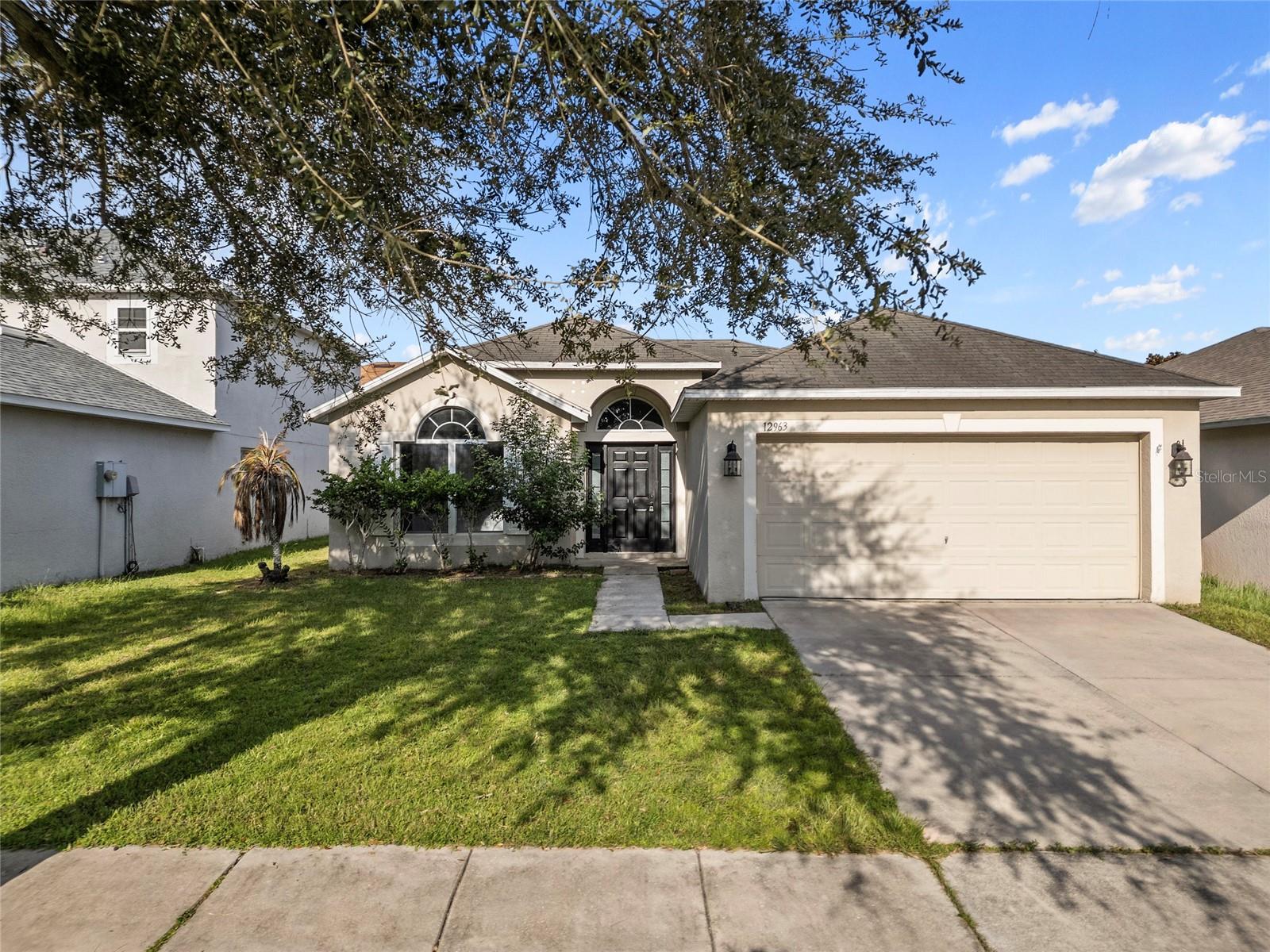 LOW HOA and no CDD! This updated Riverview home features three large bedrooms and two full bathrooms with a functional, open layout. Modern gray LVP flooring runs throughout the main living areas, and large windows provide excellent natural light. The kitchen offers generous counter space, a bar-height seating area, stainless steel appliances, a closet pantry, and well-maintained cabinetry. The primary bedroom easily fits a king-sized bed and includes a large walk-in closet and an en-suite bath with a soaking tub, extended vanity, and separate shower. The secondary bedrooms are well-sized and located on the opposite side of the home, sharing a full hall bathroom. A spacious two-car garage adds convenience, and sliding doors from the dining area lead to a private backyard with plenty of room to enjoy outdoor living.Located in the quiet Covewood community, this home sits away from major road noise but is just minutes from Big Bend Road, US-301, and I-75 for an easy commute to MacDill AFB, Tampa, or Bradenton. Close to shopping, dining, schools, parks, and a short drive to the Gulf beaches.