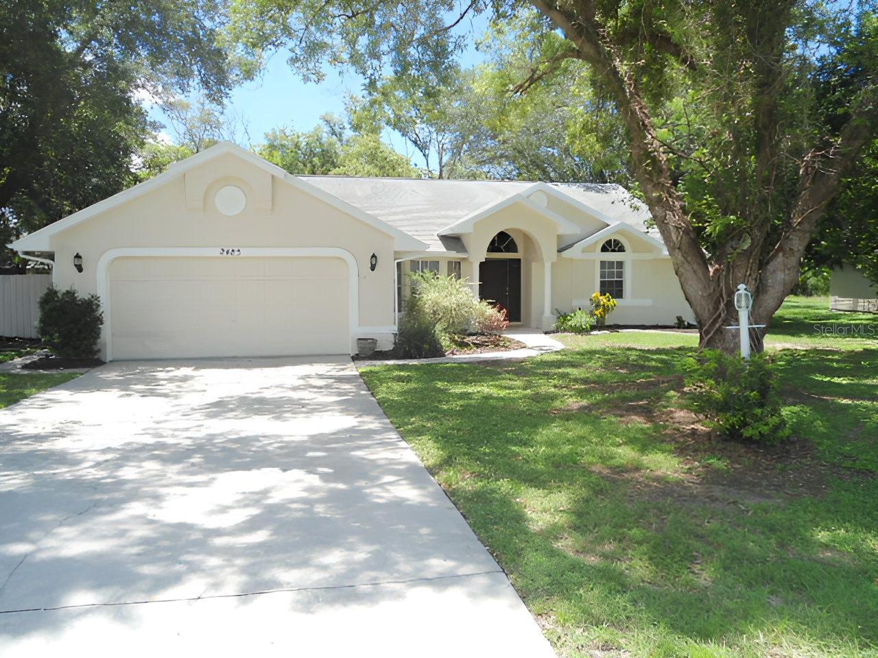 Move-in ready three-bedroom two bath home centrally located in Spring Hill. This home features an eat-in kitchen with breakfast bar, pantry and French doors; the living room has a vaulted ceiling and pocket sliders that open up to the screened in lanai; a formal dining room overlooks the front yard; the primary suite has a vaulted ceiling and the primary bath has a separate tub and shower; bedrooms two and three are on the opposite side of the home and share the hallway bath with dual sinks; and the inside laundry room has a utility sink and storage cabinets. This home has been freshly painted inside and out, all three bedrooms have new carpeting, and the living room and dining room has new laminate flooring. The spacious screened-in lanai overlooks the large fenced in back yard with a storage shed. The roof is five years old.