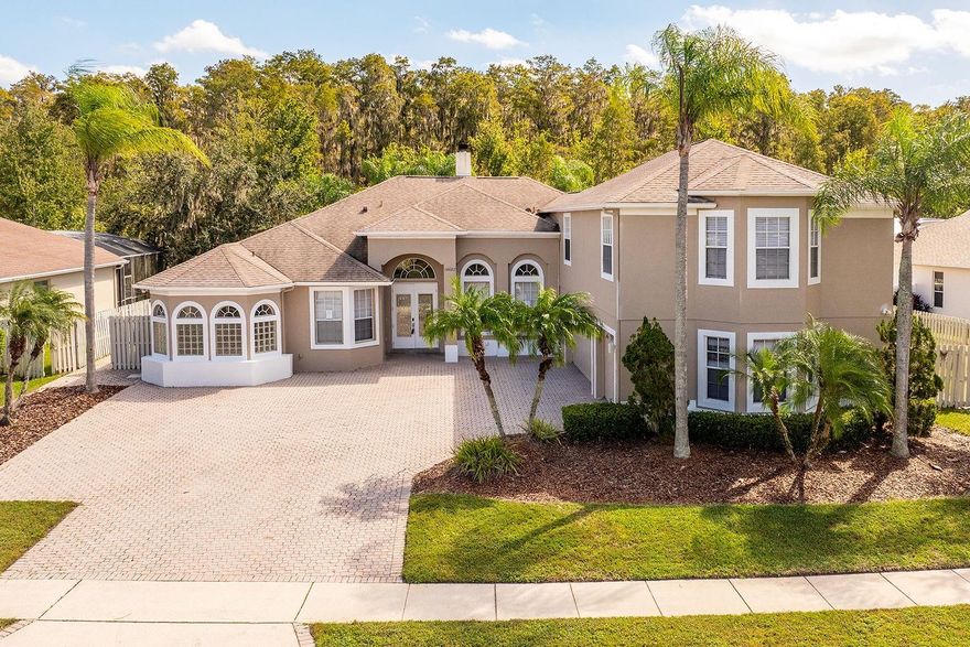 This well-positioned home presents excellent potential with flexible living spaces, a serene backyard, and a huge upstairs bonus room, providing the perfect opportunity to customize. Inside features five bedrooms and four-and-a-half-bathrooms with an open concept living area that boasts high ceilings, fantastic natural light, and easy-to-clean tile flooring throughout. The well-appointed kitchen includes a breakfast bar, tile backsplash, and double sinks for efficient meal preparation, and plenty of cabinetry for effective storage in between meals. Upstairs, the expansive bonus room measures approximately 22x37, and includes a full bathroom, creating the ultimate flex space ready to accommodate any lifestyle need. Perfect for relaxing or entertaining, the stunning outdoor space offers the perfect backdrop boasting a serene conservation view with two covered areas and a glistening in-ground pool and spa, all screen enclosed to ensure maximum comfort at any time of day. The three-car side entry garage provides ample parking, while the built-in shelving adds functional storage solutions throughout. Located moments from community amenities, Osprey Park, schools, multiple major shopping centers, and highway access, this home provides everything needed right at your fingertips. Its versatile design combined with its sizable living spaces and preserve setting creates a property that is ready and waiting for you. Don't miss this incredible opportunity - schedule your showing today and unlock its amazing potential!