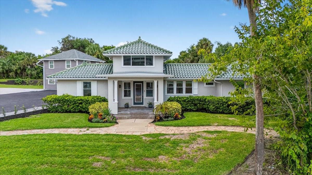 Rare Family Compound in the Heart of Daytona Beach. On offer for the first time in years is what can best be described as a Family Compound. The beautiful three bedroom three full bath main home was originally constructed in 1938 and lovingly upgraded throughout the years with the most recent renovation completed in 2018. Original features like the solid wood floors were kept to preserve the feel of historical charm. With an eye towards the future, the home has been outfitted with all new hurricane impact windows and doors. Enter the home from the formal front porch into the original living room featuring a fireplace which runs on natural gas. The chef's kitchen includes a dine-at island, granite countertops, beverage cooler and high end stainless appliances. Off of the living room you will find the first of three ensuite bedrooms. Upstairs you will find the original primary bedroom with charming built-in window seating. This room has its own mini-split for extra temperature
control and an ensuite bathroom featuring a tiled tub/shower combination. Returning to the main floor, step into the enormous enclosed sunroom which is truly the heart of the home. Natural light floods the open space creating an inviting environment for entertaining guests or participating in family gatherings. A large French door gives you access to the private primary wing. The suite has a walk-in closet with built-in shelves and a stackable washer and dryer. The spacious primary bathroom features a vanity with dual sinks, private commode closet and a glassed walk-in shower. Step outside the sunroom onto a private papered terrace with gas fire pit featuring blue glass beads that overlooks the 15' x 40' in-ground pool. The pool's depth is 8" at the deepest level and features a waterfall, three fountains and a tanning shelf. Poolside, is a stand-alone 1162 sq.ft. guest house built in 2018 that has a 392 sq.ft. covered veranda complete with an outdoor summer kitchen. This guest house was built with solid concrete block and also has hurricane impact windows and doors. Luxury vinyl plank floors unify the space which include an interior kitchen, two bedrooms sharing a full Jack and Jill bathroom and an ample great room. At the far end of the guest house is an accessible door that leads to another utility room with its own washer and dryer and a half pool bath. Just around the corner you will find a fully enclosed private outdoor shower. Exiting the wrought iron gate, walk towards the third structure of this compound. It was an original stand along garage built in 1938 but has since been converted into a two car garage with an attached studio complete with a full bathroom. The studio is 246 sq.ft. of additional living space. This extraordinary offering if truly one of a kind. Additional features include an imported Spanish ceramic tile roof on the main home, architectural shingle roofs on both the guest house and garage, owned whole house water filtration system, two tankless hot water heaters, brand new pavered driveway and motorcourt, fresh landscaping, a smart irrigation system that runs off a private irrigation well, whole house Generac generator servicing both the main house and guest house and a plumbed 16 x 16 poured concrete and papered pad where the heated spa currently sits. The spa itself does not convey.