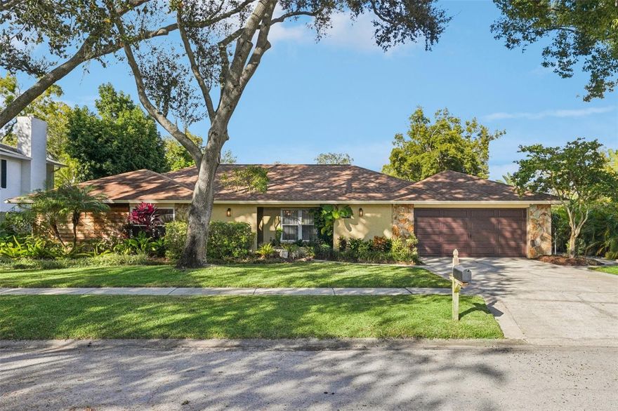 Nestled on a quiet cul-de-sac in the heart of Carrollwood, this impeccably maintained estate offers the ultimate Florida lifestyle. The backyard is a true resort-style oasis, featuring a heated saltwater pool and covered spa—newly refinished just two years ago—alongside a fully equipped outdoor kitchen. The grounds are a botanist’s dream, boasting a tranquil fish pond and a lush edible garden with avocado, starfruit, key lime, dragon fruit, pomelo, Florida peach trees and more, all framed by mature trees and manicured landscaping.

The interior is headlined by a gourmet chef’s kitchen, anchored by an impressive double-slab granite island, Thermador Induction stove and Frigidaire Professional appliances. Designed for modern productivity, the home includes an office with custom built-ins perfect for remote work. Every detail has been curated for comfort and peace of mind, from the whole-home water softener to the Window World impact windows, which include a transferable lifetime warranty paid for by the seller. Unrivaled energy efficiency and structural integrity define this residence, featuring a roof and A/C system both approximately six years old, along with 10-inch foam attic insulation. Located just minutes from premier shopping, dining, and major roadways, this home seamlessly blends luxury, sustainability, and convenience. Schedule your private tour today to experience this Carrollwood gem. TV on back porch conveys.