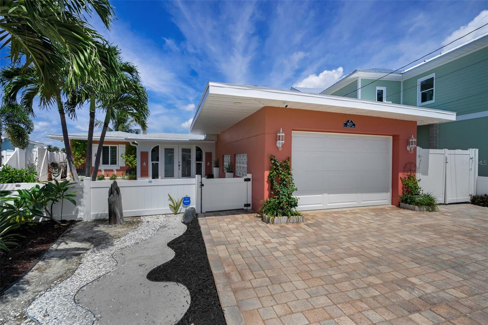 Turn-key 4BR/2BA Madeira Beach waterfront home with 71 feet of seawall, deep-water access, a 10,000-lb Davit Master boat lift, and additional berths for boats up to 38 feet. The entire waterfront side of the home features impact-rated sliders and PGT windows to capture stunning views. Watch dolphins play morning and night, and enjoy breathtaking sunrise and sunset views right from your backyard. The dock is fully equipped with electricity and water. Interior features include porcelain tile flooring, recessed lighting, plantation shutters, and a 19x13 bonus entry room with custom tile. The open-concept layout connects the living, kitchen, and dining areas to a peaceful flex nook outside the primary bedroom, perfect for reading, yoga, or a creative space. The kitchen offers quartz countertops, a gas stove, a wine cooler, and New stainless steel appliances. The primary suite includes dual vanities, a custom shower, a skylight, and a spacious walk-in closet. Other upgrades include a new 200-amp electric panel, mini-split units, a gas dryer, and blown-in attic insulation. The garage features a hurricane-rated door, LED lighting, and built-in storage. Additional highlights: whole-house water purification system, electric roll-down shutters, new gutters and drainage, and generator-ready propane hookup. Located just minutes from open Gulf waters. Walking distance to the beach and just down the block from the Elks Lodge, where you can sit poolside. This is authentic coastal living. Don’t let this one get away.