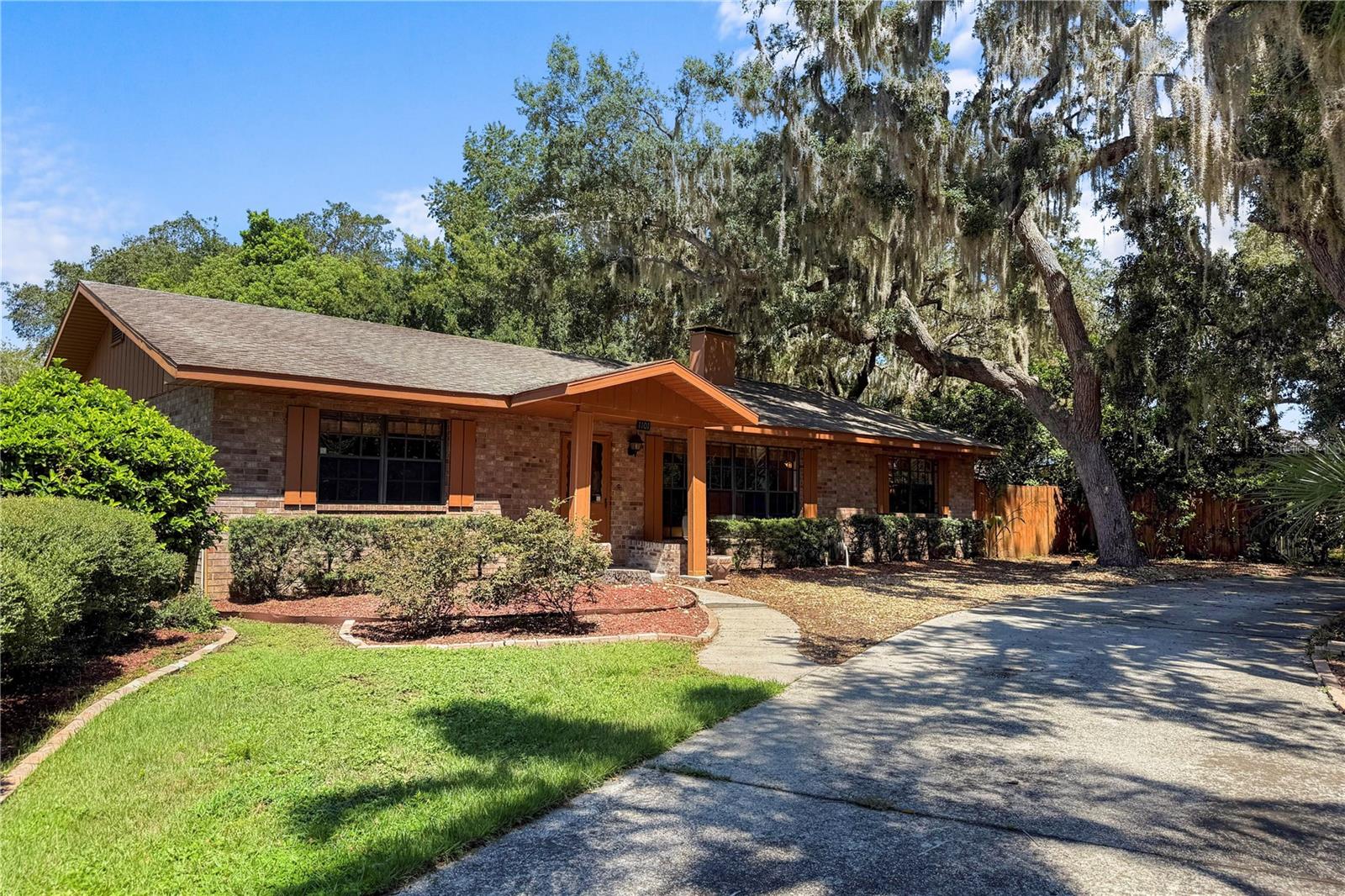 Welcome to the delightful little town of Howey in the Hills! A quaint community nestled between Clermont and Tavares. Just around the corner from the historic Howey Mansion, this spacious 1978 ranch style home has 2,366 square feet of living space, sits on a 1/3 acre corner lot and has no HOA! The circular drive has nostalgic oaks and mature landscaping framing the vintage brick and hardwood exterior. Quality of construction and of course location are the home owners favorite features about his property. We encourage you to look in the attic at the hearty wood slats and craftsmanship of this time, definitely not cookie cutter! Currently a more masculine vibe, but don’t overlook the bones of this expansive layout to create a transitional, classy space. The rooms are large and the possibilities are endless. An original stone fireplace adds a rustic appeal and real wood fire warms most of the living space! The hearth is a cozy spot to sit and the mantle spans the wall to display your favorite things! The home has 2 primary bedrooms with ensuite baths, huge closets and ample windows. The 3rd bedroom option measures 25 x 15, located just off the kitchen. Currently used as a family room and storage, super cozy with tongue and groove ceilings, antique furnace and access to the screened porch. The laundry/hobby room could also take on another purpose, point being the square footage is there to create the space you need inexpensively. The main great room is massive, with large built-ins hiding even more space! The kitchen is positioned perfectly to enjoy everyday activities with tons of room to expand! Great the way it is, but why not capitalize on the potential of your next investment?! The rear entry garage means an extra driveway and a private place to tinker and do projects! You will also be sharing a zip code with the world-famous Mission Inn Resort, this means you are literally minutes away from a full service spa, (2) 18-hole golf courses and 4 specialty restaurants! A wedding destination for some will just be Sunday brunch for you and your family! Another special treat is the Yalaha German Bakery! Properly named Lake County, “Howey” sits along the shores of the Harris Chain of Lakes. Whether you’re into boating or fishing, you’ll love the ability to visit different cities and even access the intracoastal waterway! A favorite stop is Historic Downtown Mount Dora, a destination city for boutique shopping, dining at restaurants like The Goblin Market and Pieces Rising and events year round! HVAC 2018, water heater 2021, Drain Field 2021, tile and carpet. Florida’s Turnpike is just 5 miles away on Hwy 27 with convenient access to Winter Garden and Greater Orlando.