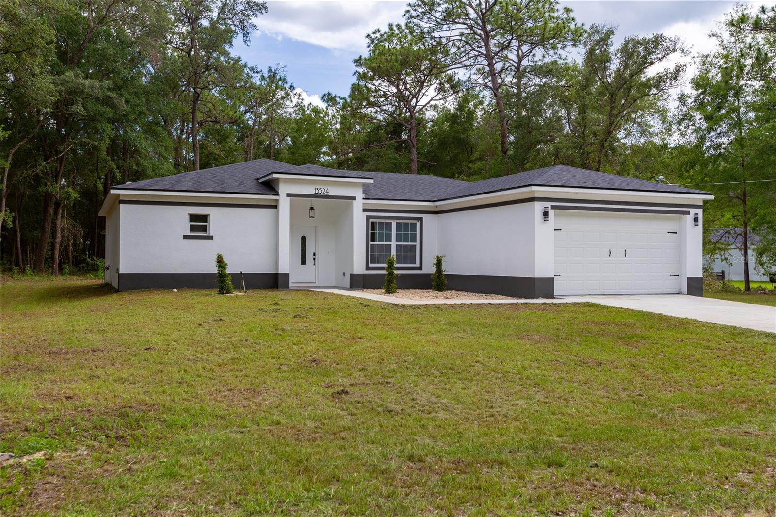 ONE Acre & No HOA __ Seller will pay $10k to buyer's closing if choose to work with preferred lender. Modern 3/2 block construction with a den/Office that could be used as a 4th Bedroom. The elegance in this home boosts over $15k in upgrades, located in the beautiful Rolling Hills. Enter the home through the beautiful wide & Tall entry into the open living/dining space with an extra room/ den to the right. Stunning views from sliding glass doors in the living room onto your extra long covered back patio and the oversized back yard with plenty of space for a pool and more. High vaulted ceilings and the amount of windows make this home airy and bright. The kitchen features solid 42" Shaker wood cabinets, soft close, Quartz Island & countertops, beautiful backsplash & Modern finishes, stainless steel appliances, pantry, and a beautiful dinning area that overlooks the backyard nature through the window. Luxury vinyl plank floor throughout all the home. The master bedroom offers lots of space with tray ceiling and a EXTRA Large Walk In Closet. Come see the stunning oversized shower with rain head & european drain. His and hers vanities (with Waterfall Faucets & Quartz conters) give extra space to the buyer with anti fog/light up rounded Mirrors. Separate toilet room. The other side of the home features 2 guest bedrooms with large windows, guest bath with tub/shower with European Waterfall Faucets and linen closet. Large inside laundry room and 2 extra storage closets on the hall for the family needs. All throughout the home you have upgraded light and plumbing fixtures. The covered front and back patio invite to enjoy the quiet of this neighborhood. Oversized 2 car garage. Stunning backyard for all your entertainment or storage needs. Home is ready for your family and all your toys. Ride the ATV through the neighborhood, park the rv on your large 1.2 acre property. Located in Rolling Hills, close to Supermarkets, Restaurants , WEC, HITS, Rainbow River and more.** Builder offers extended 2-10 warranty.
