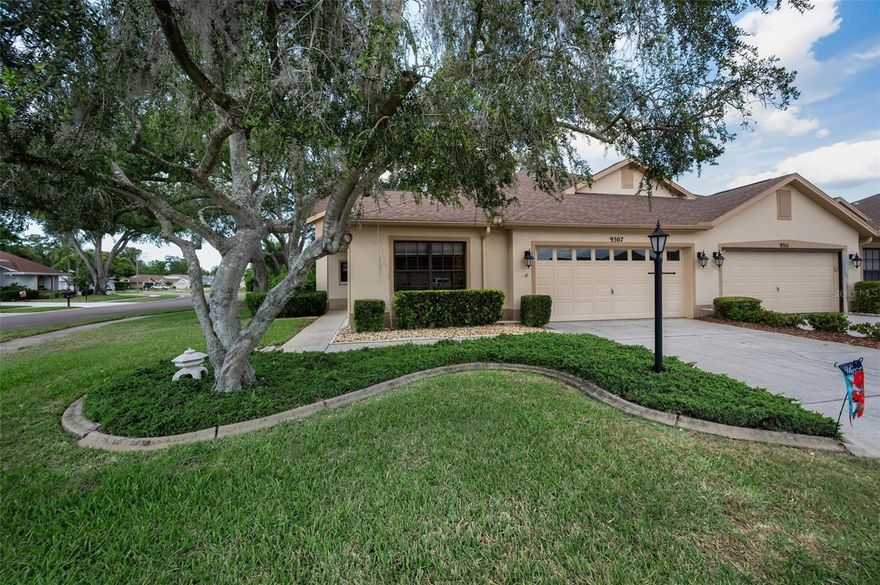 This charming 2-bedroom, 2-bath villa on a desirable corner lot in Timber Greens offers the perfect blend of low-maintenance living and resort-style amenities in a welcoming 55+ gated community. Designed with your comfort and leisure in mind, this home delivers everyday convenience alongside an active, social lifestyle. Inside, you'll find a thoughtful layout that includes a combined living and dining area for easy entertaining, a large eat-in kitchen outfitted with stainless steel appliances, modern resin countertops, and a functional island for meal prep and casual gatherings. The primary bedroom features generous walk-in closets and an updated bathroom with a walk-in shower, while the spacious second bedroom provides flexibility for guests, hobbies, or a home office. A dedicated laundry room with washer and dryer adds convenience to your daily routine, and the two-car garage offers secure parking and extra storage .Step into the spacious enclosed lanai and take in peaceful pond views, a serene backdrop for morning coffee or evening relaxation. This private outdoor retreat extends your living space and invites you to enjoy Florida's beautiful weather year-round. Timber Greens brings you a full lineup of community amenities, including an 18-hole par 71 golf course, clubhouse with pro shop, pool, spa, tennis and pickleball courts, bocce, shuffleboard, arts and crafts programs, a lively 19th Hole Bar and Grill, and a card room for socializing with neighbors. Whether you're pursuing an active hobby or simply enjoying the company of friends, this community delivers the lifestyle you've been looking forward to. Schedule your private showing today!