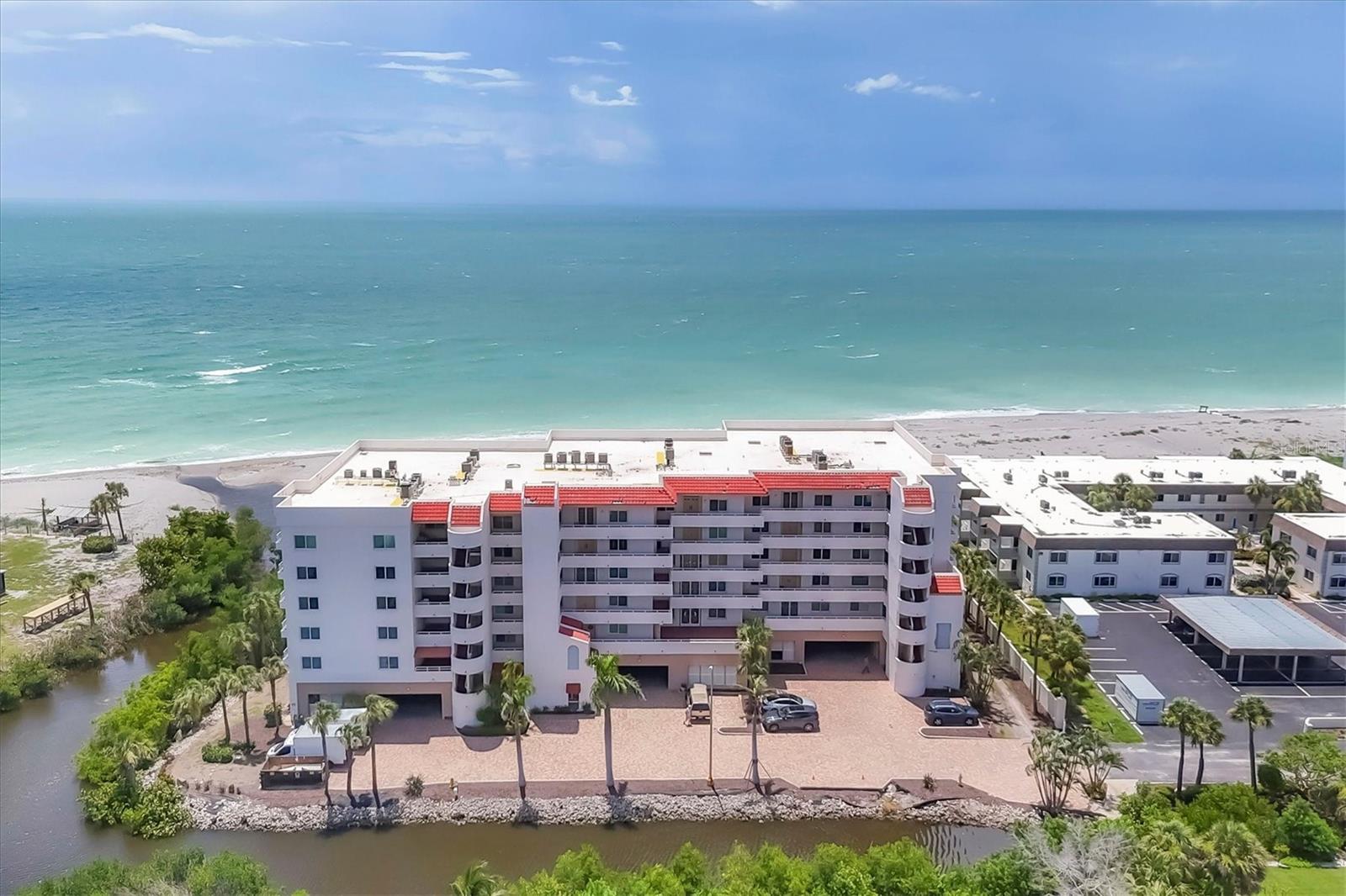 One or more photo(s) has been virtually staged. Rarely available corner unit! Spacious 3BR/2.5BA (plus office/den that could be a 4th bedroom) in Island Shores, a private beachfront mid-rise on Venice Beach. Breathtaking sunset and Gulf views from the 30-ft enclosed Florida room plus two side balconies looking over the Island of Venice. Features include hurricane-impact windows/doors, Trane A/C, Bosch tankless water heater, remodeled bathrooms, large walk-in closets, hidden pantry, built-in bar, newer appliances, and updated tile flooring. Community offers secure garage, guest parking, clubhouse with kitchen, guest suites, heated pool, fitness room, and private beach access. Walk to shops, dining, marinas, and Historic Downtown Venice. Available Fully furnished with high-end décor.