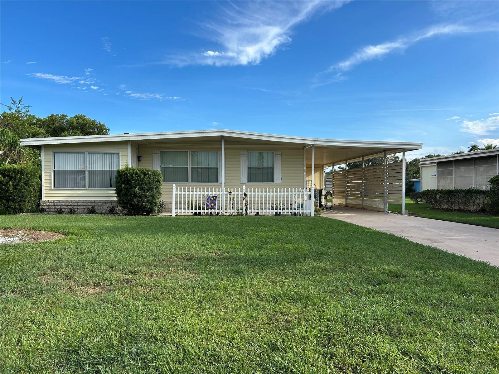 Such a nice community with all the activities, clubhouse and more. Nice size Florida room. Light and Bright thru out. Kitchen offers nice cabinetry, countertop, newer refrigerator. Master bedroom good size. 2nd bedroom opens to main bath. Florida room door leads out to fenced small area. Home features a separate utility room. 55 plus community which one will enjoy. 2 community pools, club house and more. A golf cart community close to downtown Tavares.