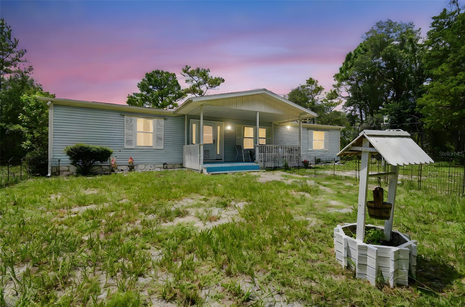 Beautifully Updated 3-Bedroom Home on 1 Acre. Come explore this light-filled and beautifully updated 3-bedroom, 2-bath home set on a spacious 1-acre lot. In 2024, the home received an impressive list of upgrades, including new windows, PVC plumbing, front door, gorgeous flooring, modern appliances, kitchen counters, ceiling fans, LED lighting, hot water heater, AC packaged unit, and freshly sealed back roof and carport. The main roof is only 8 years old, offering peace of mind for years to come. Step inside to a welcoming and bright interior, featuring a huge family room, a separate dining area, and an updated kitchen with a large pantry (with washer hookup). The outdoor space is just as inviting, with a screened lanai, plenty of covered parking under the carports, and a storage shed. Enjoy the benefits of a private well and septic system. This property offers the perfect blend of modern updates and room to spread out. Schedule your showing today! Make sure to drive in off of Gum St