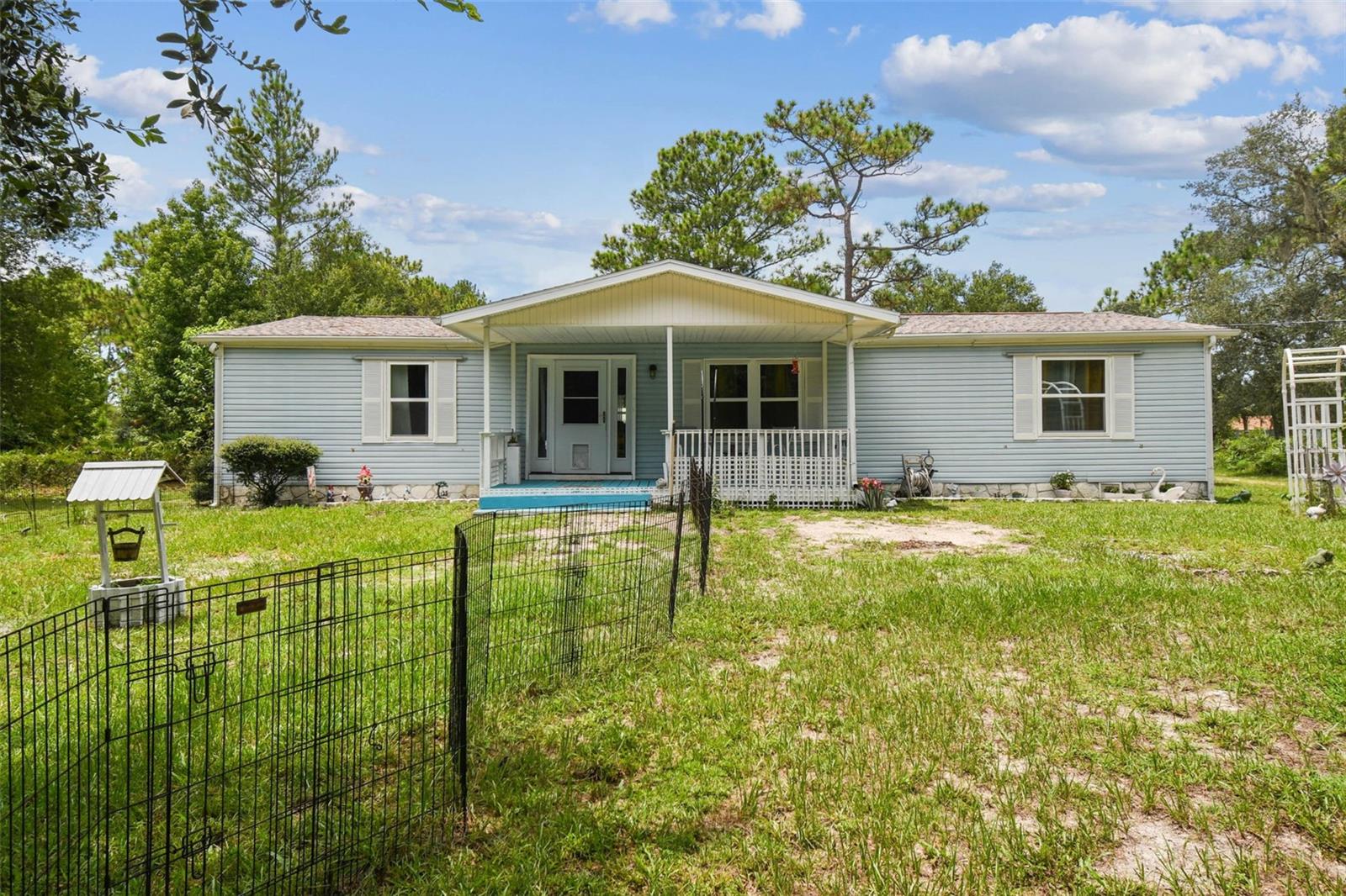 Beautifully Updated 3-Bedroom Home on 1 Acre. Come explore this light-filled and beautifully updated 3-bedroom, 2-bath home set on a spacious 1-acre lot. In 2024, the home received an impressive list of upgrades, including new windows, PVC plumbing, front door, gorgeous flooring, modern appliances, kitchen counters, ceiling fans, LED lighting, hot water heater, AC packaged unit, and freshly sealed back roof and carport. The main roof is only 8 years old, offering peace of mind for years to come. Step inside to a welcoming and bright interior, featuring a huge family room, a separate dining area, and an updated kitchen with a large pantry (with washer hookup). The outdoor space is just as inviting, with a screened lanai, plenty of covered parking under the carports, and a storage shed. Enjoy the benefits of a private well and septic system. This property offers the perfect blend of modern updates and room to spread out. Schedule your showing today! Make sure to drive in off of Gum St