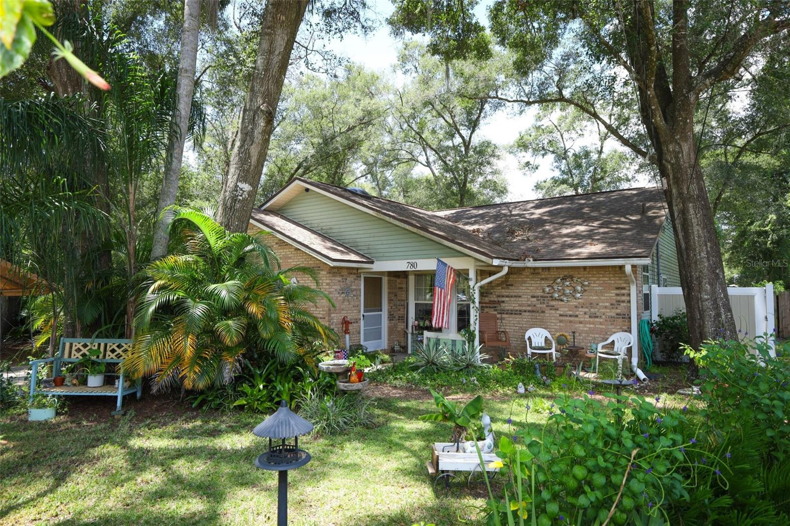 Welcome to this charming 3-bed, 2-bath ranch-style home situated on nearly a ¼ acre with NO HOA! Enjoy the privacy this home offers as you look out at your SPACIOUS front yard from your covered porch surrounded with mature landscaping. Step inside the foyer to an OPEN LAYOUT and endless possibilities. The kitchen features UPDATED counters, a recently replaced refrigerator and stove and space for a coffee bar. The current owners added a touch of personality with decorative cabinet accents that are easily removal if preferred without. NATURAL LIGHT fills your dining area through bay windows. The main living area has been UPDATED with durable wood-like-tile for easy maintenance. The SPLIT LAYOUT offers a private primary suite with a WALK-IN CLOSET and EN-SUIT bath with walk-in shower. On the opposite side, the two secondary bedrooms share a central bathroom with a dedicated hallway. Step outside through double sliding glass doors with internal blinds into your large, SCREENED-IN PORCH and FULLY FENCED yard complete with TWO STORAGE SHEDS, a garden, gazebo, fire pit and a chicken coop. A unique bonus is the township owned property next to your home, preserving your privacy and offering access to a patch of pineapples for residents to enjoy. The home features an attached 2-CAR GARAGE with an optional screen door, offering the flexibility to use the space for gatherings, workouts, or hobbies while your vehicle is parked under the carport. Additional perks include an 8-year-old roof, 4-year-old AC, 6-year-old water heater, two new storm doors and a new washer. Located in a quiet neighborhood near Stetson University, Blue Springs State Park and vibrant downtown DeLand this property provides the perfect blend of small-town charm and convenience with easy access to I-4, the local SunRail station, and Amtrak. The seller is MOTIVATED, and the home is overflowing with potential so don’t wait, bring your vision and make this home your own!