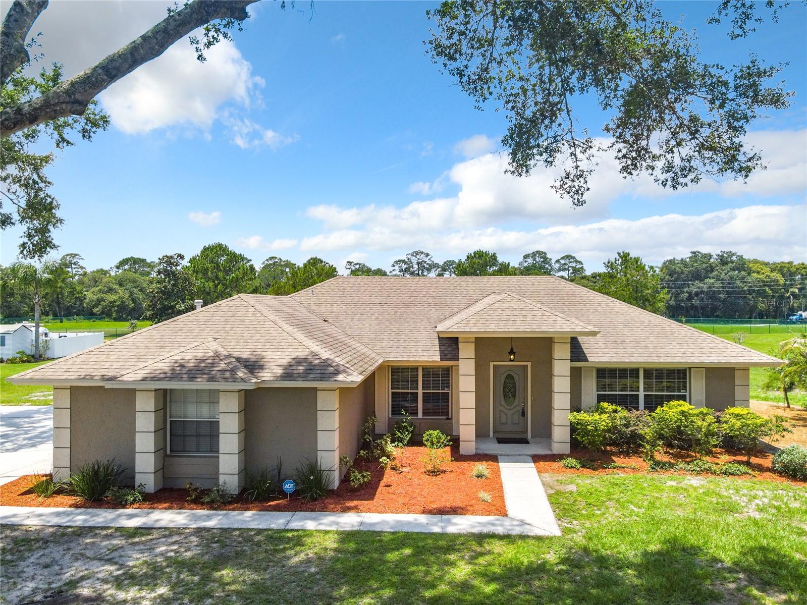 Under contract-accepting backup offers. Introducing a stunning Contemporary home nestled in the highly sought-after neighborhood of Greater Country Estates. This exceptional residence underwent extensive renovations in 2015, ensuring it is absolutely move-in ready. With breathtaking sunset views overlooking a serene pond and over an acre of meticulously maintained land, this property exudes charm and tranquility. The landscape boasts an abundance of mature trees, creating a serene and picturesque environment, while a delightful grape arbor adds a touch of elegance.
One of the standout features of this home is the ample space available for your recreational vehicles or boat, as the neighborhood's voluntary HOA allows for hassle-free storage. As you step inside, you will be greeted by a professionally decorated split ranch design that perfectly balances comfort and style. The custom kitchen is a dream for any gourmet cook, complete with additional 42" tall cabinets offering abundant storage. The brushed stainless GE appliances enhance the kitchen's modern ambiance, making meal preparation a delight. total renovation in 2015, no detail was overlooked. Plumbing, doors, insulation, baseboards, flooring, textured ceilings, can lighting, and all appliances were meticulously upgraded, Schedule a showing today and prepare to be captivated by the beauty and tranquility that awaits you in this remarkable home.