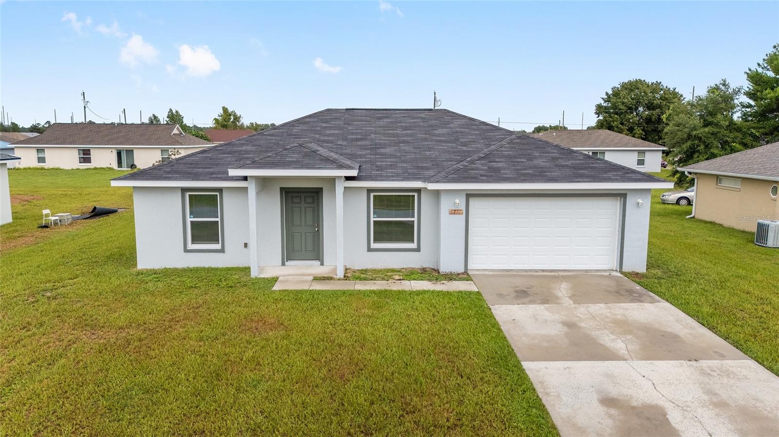 This beautiful 2020-built home offers a perfect blend of elegance and coziness. Inside, you'll be greeted by vinyl floors and vaulted ceilings, creating a bright and inviting atmosphere. With 3 bedrooms, 2 bathrooms, and an attached 2-car garage, this concrete block and stucco home features: Granite counters in the kitchen and bathrooms, Walk-in master bedroom closet, 0.23 acre lot in Silver Springs Shores. The open concept and split bedroom floor plan offer ample space and privacy, making it ideal for relaxation and entertainment. Enjoy outdoor activities and create your own private retreat on your expansive property. This home is conveniently located near amenities, with easy access to shopping, dining, and entertainment options. As a newer home, it offers modern features and construction quality. Don't miss out on the chance to see this home - schedule your showing today!