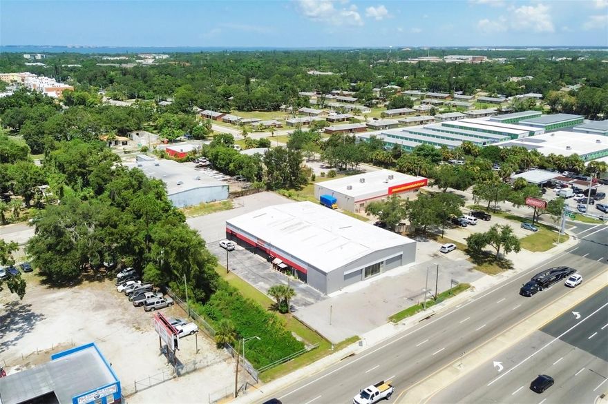 Are you looking for *A FULL ACRE* near downtown Sarasota? Would 0.98+ AC be enough? Located at 2015 N. Washington Blvd. (HWY 301), an 12,060 sq ft building, with room to expand, or add another smaller structure out back. Ample parking in front, paved driveways down both sides, to large gated/fenced parking lot out back. Complete drive around truck access, the fenced rear lot is approx 11,000 sq ft paved, w/additional 2000+/- grass area.  Glass front windows and entrance door, are between twin 18' wide x 10' high overhead doors (with room to go higher). 3 phase electric, and 3 seperate electric meters for the the 3 individual sections of the building. The front section is presently vacant at approx 4,900 sf.. The middle section, approx 5,260 sf., is leased through Dec. '26, and the rear, approx 1,900 sf., has about 1,400 sf of it leased through Dec. '26 also. The rest of the rear section (approx. 500 sq ft) is a sealed off 2 car garage with rollup door. So roughly 55% is leased right now (through 2026), and 45% is presently vacant. The front has 2 bathrooms, office and kitchen, and the middle has two bathrooms, small office and mostly open floor plan for storage. The 1,400 sq ft of rear has been built out to air conditioned office space and clerical storage, with access to the middle section. Hooked up to city water, but with septic tank, not city sewer. This building has withstood every storm that has passed it's way since being built in 1968. Even with the nasty 2024 hurricane season, there was no structural damage or flooding, just some cosmetic improvements/upgrades have been completed on the front. The complete roof was sealcoated around 2000, and skylights all resealed in 2018. Pictures posted here, show the middle with new automotive equipment in place which has since been removed. It still reflects the correct layout of the interior space presently used for storage. Again, there is absolutely no equipment (in pics) inside the bldg anymore.