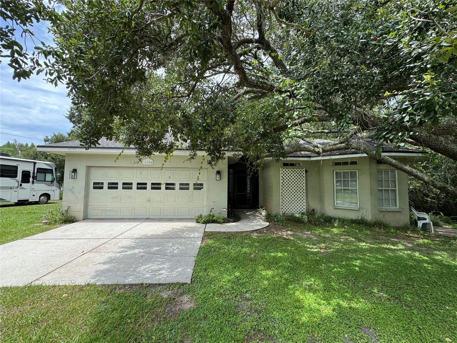 3br/2ba in main house with living, dining, eat-in kitchen, breakfast nook, utility with washer/dryer, sink and freezer and two car garage. Total living square footage: 2261. Has cabana, separate from main house, with daybed nook, no closet, living/hotel style kitchenette with apartment size fridge, bathroom and separate side entrance. Main house is currently set up as two 1/1's, rear two bedrooms are now configured as an in-law suite with bedroom, living/hotel style kitchenette with apartment size fridge, bathroom and separate rear entrance. 9'-4" ceiling heights throughout. 8' french doors and SGD to large lanai with screened in pool. Installed new A/C & air handler 5 years ago, new roof 3 years ago, resurfaced pool and new screening 1 year ago. Built 1997, with only one owner.Sits on approximately 1 acre, with well and septic.Conservation area in back and wooded creek bed along north side. Electrical outlets installed for 30 amp and 50 amp RV's, with plenty of yard for your toys. No HOA. Zoned agricultural, allowing for livestock and chickens. If you want country living with the convenience of urban living, this one's for you! Perfect for multiple generations. All appliances stay. Will leave lawn care equipment. Excellent school district!! Needs some repair and aesthetic updates.