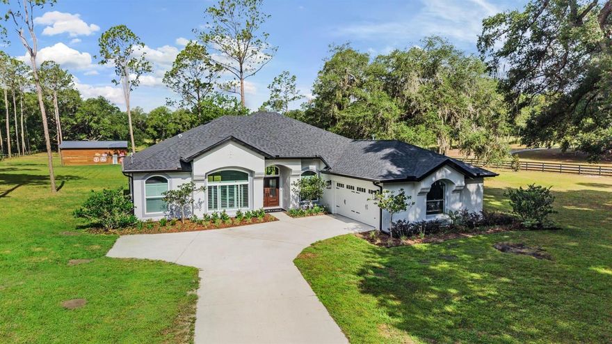 One or more photo(s) has been virtually staged. Tucked away on 5 breathtaking acres in the heart of Dade City, this extraordinary estate is the definition of luxury country living with every modern convenience close at hand. Every inch of this remarkable property has been thoughtfully redesigned with impeccable craftsmanship, timeless style, and absolutely no detail overlooked. As you pull into the property, the sprawling landscape, mature trees, and wide open skies create a picture perfect setting that feels like your own private retreat. Step through the front door and you are instantly welcomed by a bright, open concept layout filled with natural light, upscale finishes, and refined touches throughout. Every space flows effortlessly into the next, creating the ideal blend of warmth, sophistication, and functionality. The heart of the home is the beautiful kitchen featuring custom cabinetry, striking countertops, premium appliances, and an oversized gathering space, this kitchen was made for entertaining while still feeling comfortable for everyday living. The spacious living and dining areas highlight the quality of the renovation and provide picturesque views of the surrounding property. The expansive primary suite is a true retreat, offering the perfect balance of luxury and tranquility. With generous space, a walk in closet featuring custom built in storage and a spa inspired ensuite that elevates the experience even further with a massive glass enclosed walk in shower, freestanding modern soaking tub, and carefully selected finishes that create a relaxing, resort style feel, altogether providing the ultimate private sanctuary to unwind and recharge at the end of the day. The dedicated office offers the perfect work from home setup, tucked away for privacy while still feeling connected to the home. Each of the secondary bedrooms has been tastefully updated, creating comfortable and inviting spaces, while the additional two bathrooms have been transformed with elevated finishes and thoughtful designer details that enhance the overall feel of the home. Step outside and the magic of this property truly unfolds. The expansive acreage provides endless possibilities for those dreaming of space, freedom, and a true country lifestyle. Bring the horses, chickens, and livestock because this welcoming community embraces farm life and all the charm that comes with it. The impressive 30x40 barn, complete with electric and water, is ideal for animals, hobbies, equipment storage, workshops, or creating the ultimate recreational space. Whether you are enjoying quiet mornings overlooking the property, hosting family gatherings under the stars, or simply taking in the peaceful surroundings, this estate offers a lifestyle that is becoming increasingly hard to find. Located just minutes from the historic charm of downtown Dade City, you will enjoy easy access to local boutiques, restaurants, coffee shops, farmers markets, and community events that make this area so beloved. Convenient access to the interstate also makes commuting simple, while the nearby Wesley Chapel area offers endless shopping, dining, entertainment, hospitals, and everyday conveniences just a short drive away. This is more than just a home, it is a fully reimagined lifestyle property where elegance meets wide open space, and where every detail has already been perfected for you. A/C 2026, WELL BLADDER 2026, WELL HOUSING 2025, SEPTIC SYSTEM/TANK 2025, ROOF 2024, WINDOWS 2024, WATER HEATER 2024, AND MUCH MORE!