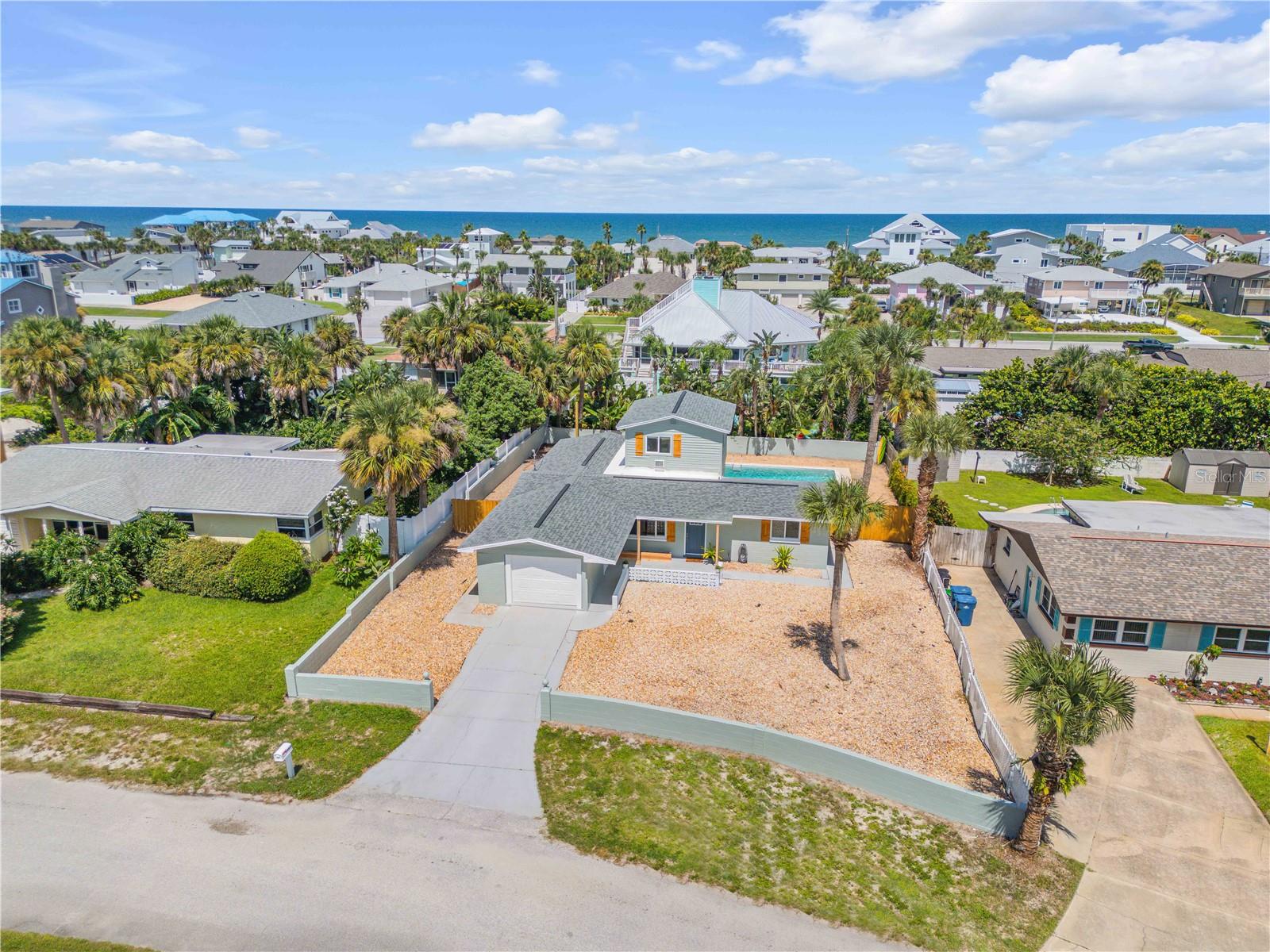 Ready to live BEACHSIDE at 4643 Katy Drive. This charming 3 bedroom, 2 bathroom POOL home is only 2 blocks from the no-driving area of New Smyrna Beach! Step inside this mid-century modern beach home offering ample space for relaxation and privacy. Fully fenced in back yard for your pets and hard-scaping = zero yard work and more playtime! Brand new luxury vinyl plank flooring throughout and new quartz countertops in the kitchen! The entire home has fresh paint inside and out. The oversized 1 car garage is perfect for storing all of your beach toys and bikes! The split floor plan design features the primary en-suite with a gorgeous pool view, the 2nd bedroom has pretty views of tropical landscaping out back and the 3rd bedroom/or Bonus room is up the spiral staircase to the second floor! This HUGE room has double closets, and sliding glass doors out to a deck that leads down to the pool and garden area. Located in the peaceful neighborhood of Silver Sands, this home provides easy access to NSB's vibrant community, popular for it's charming shops, restaurants and gorgeous coastline. It is the perfect blend of comfort and coastal living! For added tenant convenience both pool care and yard maintenance are included, as well as an indoor washer/dryer. The owner does not allow smoking in or around the home. Upon request, an application link will be provided. The application fee is non-refundable.