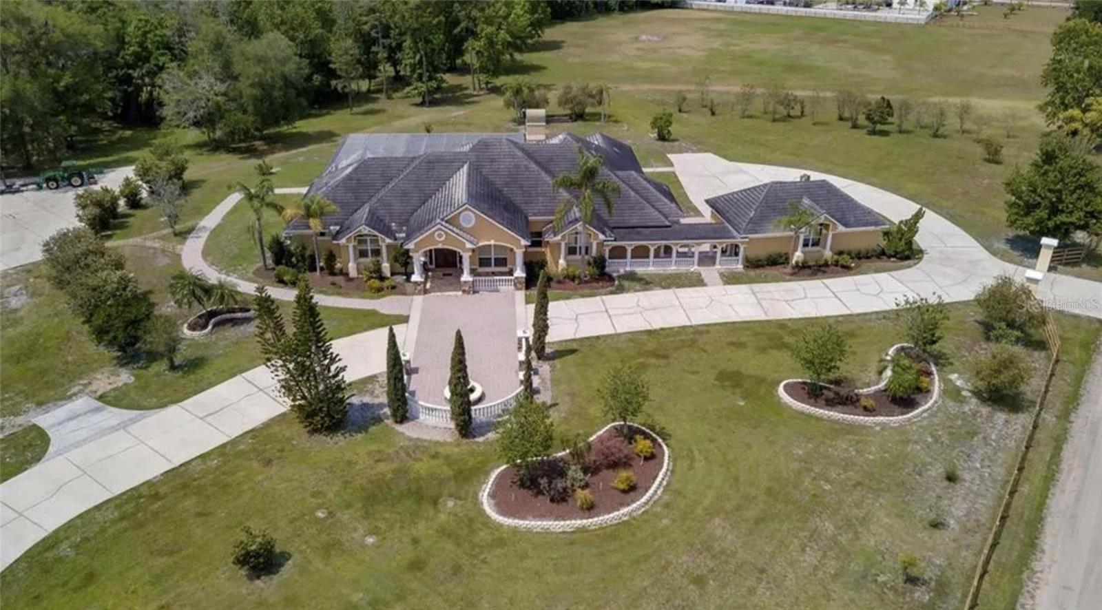 Palatial Estate on 35 Acres w/ Massive Warehouse & Development Approval!
A once-in-a-lifetime offering! This is not just land; it's a magnificent 5-bedroom, 5.5-bathroom mansion situated on a massive 35 acre compound, complete with a commercial warehouse and approved plans for a future townhome community. Experience unparalleled luxury, privacy, and limitless potential.
The Luxurious Residence: Boasting a commanding 5,044 sq ft under air, this home is designed for grand-scale living and entertaining. With 5 bedrooms and 5.5 bathrooms, it offers ample space for family and guests.
Modern Comfort & Style: While details are to be discovered, homes of this caliber often feature gourmet kitchens, expansive living areas, home theaters, game rooms, and resort-style pools—all possible in this incredible setting.
Ultimate Privacy & Legacy Living: Enjoy the rare combination of a luxurious, move-in ready estate with the privacy and scale of your own 35-acre kingdom.
The Income & Development Assets: Colossal Commercial Warehouse (6100+ sq ft): A business owner's dream. This clear-span facility with high ceilings, phase power is perfect for any enterprise, storage, or as a world-class private workshop. Generate significant income or pursue your passion project.
Pre-Approved Townhome Subdivision: The land is shovel-ready for a few unit townhome community, Develop for future profit or hold the entitlement to increase the property's value.
Unrivaled Scale & Flexibility: With 35 acres, the options are endless. Keep it as a legendary private compound, develop a portion, or build a mixed-use legacy project. Short-term rentals are approved for future builds.
Prime Location & No HOA: Total freedom just minutes from Disney, major highways, and all Kissimmee amenities. The property is paved, fenced, and has multiple access points.
This is more than a property; it's a legacy. A statement. A universe of possibilities.
Contact us for a private showing of the estate and full development portfolio. Confidentiality assured.