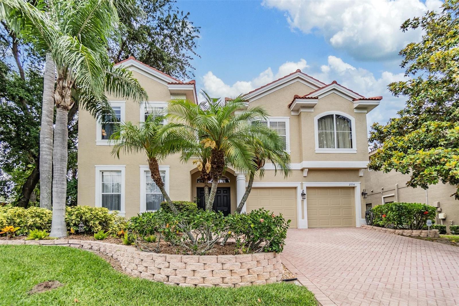 Experience luxury living in this spacious two-story home nestled within the gated community of Cypress Knoll. With over 3,500 square feet, this impressive residence features four bedrooms, three full baths, one half bath, and a three-car garage, all situated on the largest lot in the community. As you approach the property, you'll be welcomed by meticulously maintained landscaping, a charming paver driveway, and a pathway leading to a double-door entry. Upon stepping inside, the elegance of the space is immediately apparent. High ceilings and oversized windows allow natural light to flood the home, beautifully complemented by freshly painted neutral tones. To the left of the entry, the oversized dining room impresses with its detailed coffered ceiling, picture frame porcelain tile flooring, and a stunning crystal chandelier, making it perfect for family gatherings and holiday meals.
The kitchen is a chef's paradise, equipped with granite countertops, 42-inch brown cabinets, a cooking island with a lighted hanging pot rack, and a 40-bottle wine cooler. The stainless steel appliances include a 2024 cooktop, oven, microwave, and a motion sensor faucet. This eat-in kitchen area seamlessly flows into the family room, which features clerestory ceilings, surround sound speakers, double-blade ceiling fans, and stunning views of the pool and spacious yard through sliding glass doors.
The master suite offers a luxurious retreat with tray ceilings and a spa-like ensuite bathroom. Relax in the jetted soaker tub, double vanity, custom-painted walls, new corner glass shower (2024), and custom walk-in shower with sliders leading to the pool. Outside, the sparkling pool, with a new gas heater (12/2024) for both the pool and jacuzzi, is enhanced with stone features and a soothing waterfall. The tropical landscaping, screened enclosure, and beautifully landscaped fenced yard provide an ideal setting for entertaining and BBQs.
The home offers additional features such as three guest bedrooms and two guest bathrooms, each with a tub. There's also a convenient half bathroom and a creative nook, ideal for setting up an office. A spacious bonus/game room, adorned with crown molding, is perfect for hosting a pool table and games or setting up a large TV for movie nights. The wet bar enhances the entertaining experience, making it a fantastic space for gatherings. The home is equipped with practical features such as a brand-new tile roof installed in 2023 with a transferable warranty, dual A/C units for comfort during hot summer days, a central vacuum, a 6250-watt generator, and an energy-efficient heat pump water heater. Cypress Knoll offers residents convenient access to the charming downtown Safety Harbor, with its shops, restaurants, and cultural attractions. Enjoy the luxury of traveling in your golf cart to explore nearby beaches and the airport. This home is truly impressive—schedule your showing today!