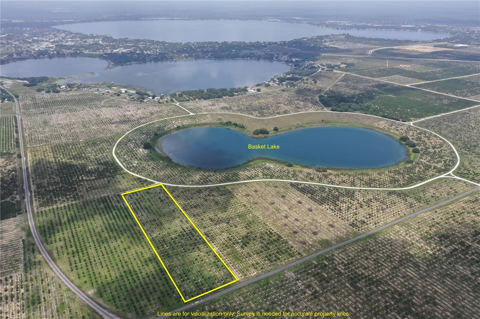 9.81± Acres of Prime Lake-View Residential Development Land — Designated for Medium-Density Residential use, allowing you to preserve valuable development entitlements while benefiting from current Agricultural zoning to keep taxes low. Water and sewer along paved road frontage on Arbuckle Creek Road to the south. Just across the road, you’ll find lakefront multi-family apartment complexes and established lakefront communities, with existing utilities already servicing these adjacent developments—positioning your property for a smooth and efficient future build.