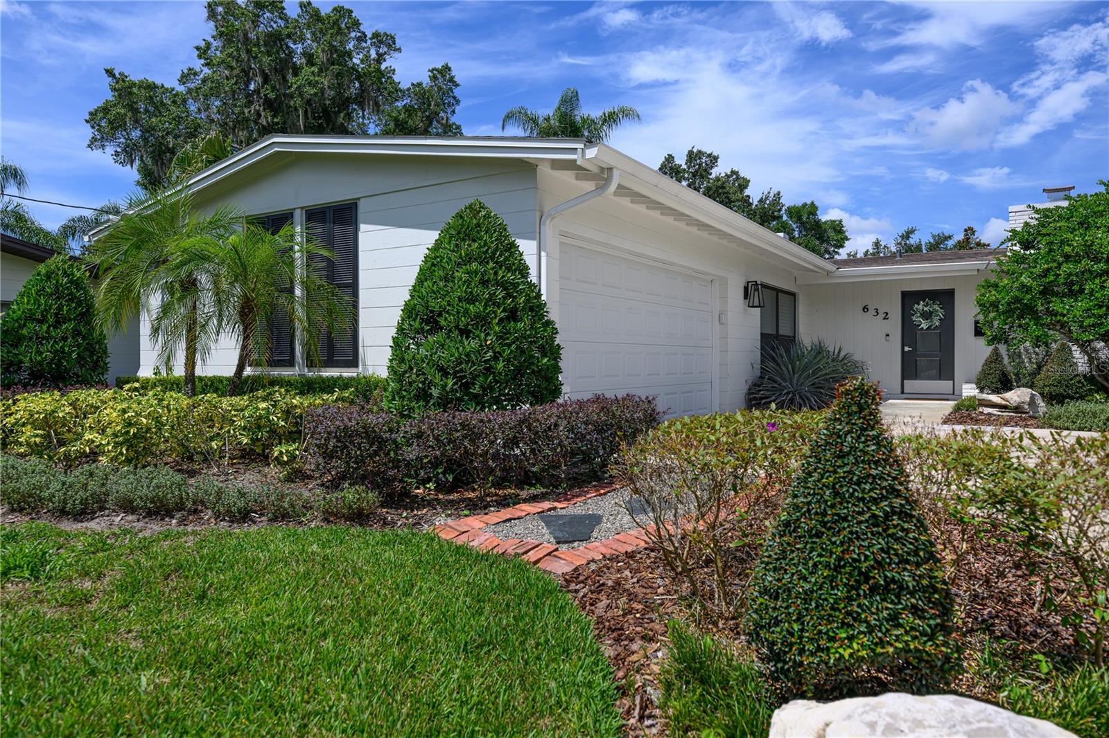 Step into this meticulously maintained, move-in ready mid-century modern beauty, nestled in the heart of the higly sought-after Oakland Shores neighborhood in Maitland, Florida. Situated on an elevated lot, this home boasts all new landscaping, a newly painted exterior, and exceptional curb appeal. The solid block construction offers both durability and timeless style, with three spacious bedrooms and two full bathrooms
Enjoy vaulted ceilings and a cozy brick wood-burning fireplace in the spacious living room, with elevated windows that flood the space with natural light. The seamless flow from living to dining creates a perfect setting for both everyday living and entertaining.
The kitchen featuring sleek granite countertops, stainless steel appliances, and pull-out storage in the cabinets and pantry. A large window above the sink offers a view of the lush backyard, while the adjacent eat-in nook provides a charming spot for casual meals.
Newer laminate flooring flows throughout the home, with tile accents in the kitchen, dining room, nook, and bathrooms. Both bathrooms have been thoughtfully updated, with the primary bath receiving a luxurious remodel in 2022—complete with a thermostat-controlled floor warming system for extra comfort.
The primary bedroom is a true retreat, filled with natural light and featuring a custom walk-in closet. The secondary bedrooms are generously sized, with one offering two large closets, providing ample storage space.
Recent Upgrades: This home has received over $30K in all new landscaping both in the front as well as the backyard. New walkways have been added, all new irrigation, and PVC fencing in the backyard. Other updates include a new garage door, exterior paint, shutters, and fresh hardware on interior doors. HVAC air handler (2022), and a new septic tank and drain field (2022). Home has double pained windows and tankless water heater.
Relax and unwind on the large 33’ screened porch, perfect for enjoying the Florida weather at any time of day. The beautifully landscaped backyard is complete with a fire pit, ideal for cozy evenings with family and friends.
This home’s location couldn’t be better—close to shopping, restaurants, grocery stores, and with easy access to I-4. Plus, there’s no HOA to worry about! Whether you’re commuting or enjoying local amenities, this property offers the best of both worlds.
This is a rare opportunity to own a beautifully updated mid-century home in one of Maitland's most desirable neighborhoods. Schedule your showing today and start imagining your new life here!