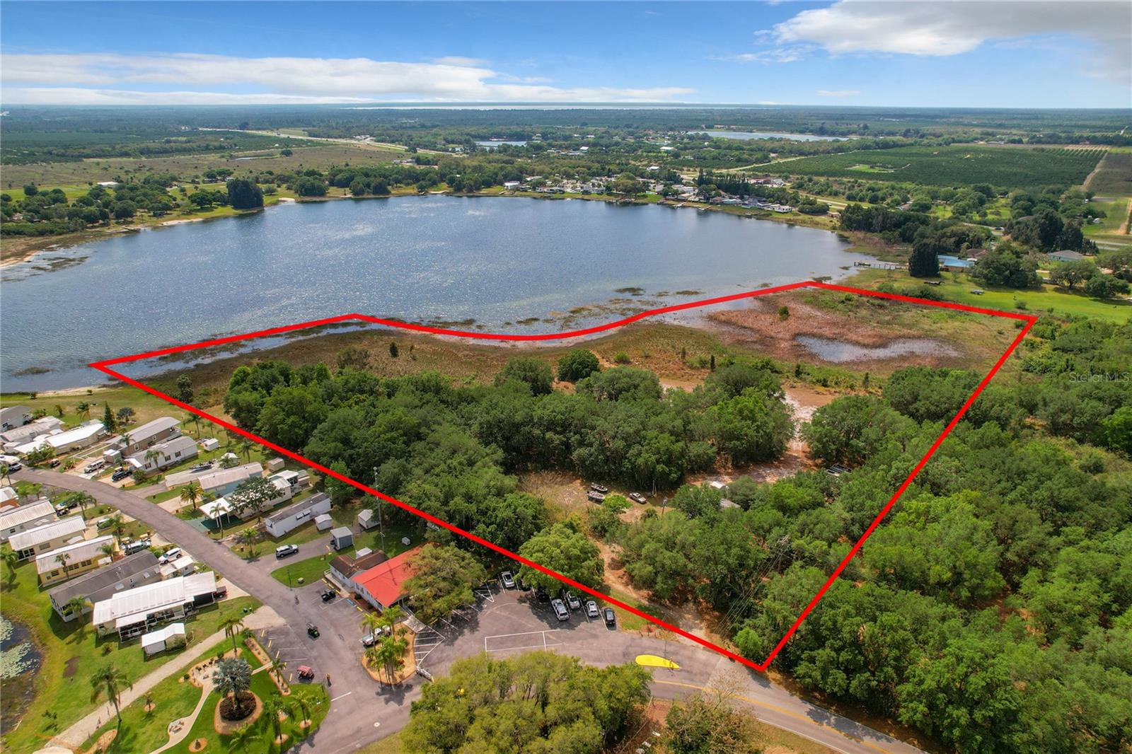 Investors, developers and home buyers looking to build their dream home/homes all have the rare opportunity to own over 11 acres, lakefront property on beautiful Saddlebag Lake. Total of three lots being sold together including a 3 bed/2 bath mobile home. Impact fees paid, well, septic set up and electricity connected. Saddlebag lake currently has a mix of mobile park communities, vacation homes and residential living. Bring your boat, watercraft’s, enjoy the tranquility of this beautiful piece of land nestled among orange groves, and conveniently located to State Highway 60, shopping and dining. Call today for additional details or to schedule a private showing.