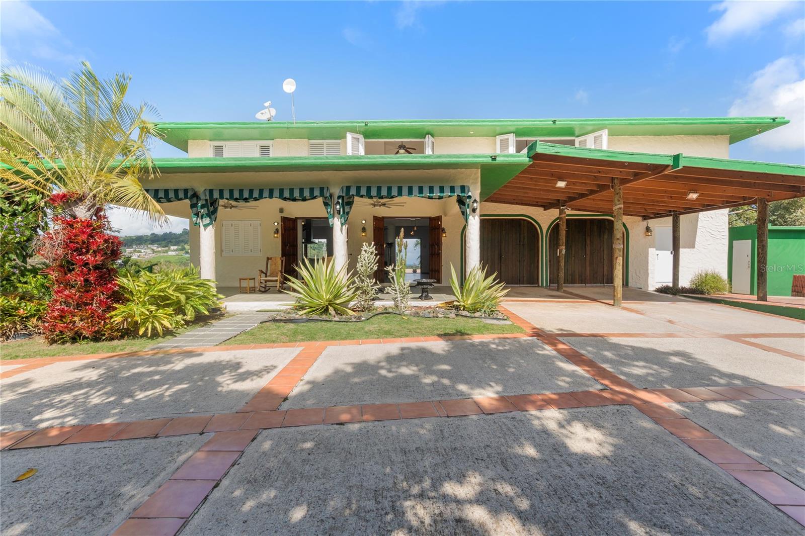 Nestle in the lush hills of RÃo Grande, this tropical retreat offers breathtaking panoramic views from every angle. Surrounded by nature, this home provides a unique vantage point where you can take in the majestic beauty of El Yunque National Rainforest right from your doorstep. Designed to embrace the stunning landscape, with high vaulted ceilings, large windows, and elegant wood finishes create a bright and airy atmosphere, while multiple access points lead to a spacious covered terrace perfect for entertaining or unwinding in the fresh Caribbean breeze.
Step outside to your private paradise, where a beautifully designed infinity-edge pool and spa overlook the rolling hills and verdant scenery. The pool and spa can be heated separately, and the pool’s rapid water flow adds an extra touch of relaxation and luxury. The expansive wraparound terrace, supported by rustic wooden columns, offers the perfect setting to relax, entertain, or simply soak in the uninterrupted views of the Caribbean sky and tropical surroundings. Whether you're lounging by the pool or enjoying a sunset from the covered patio, the serene ambiance of this property is unmatched.For added convenience and security, this home is equipped with a gas-fueled generator, ensuring uninterrupted power.
Located in the exclusive gated community of Villas del Rey, this home offers privacy while being just minutes from world-class golf courses, pristine beaches, and the wonders of El Yunque. this property embodies the perfect blend of elegance, comfort, and the unparalleled beauty of Puerto Rico’s natural landscapes.