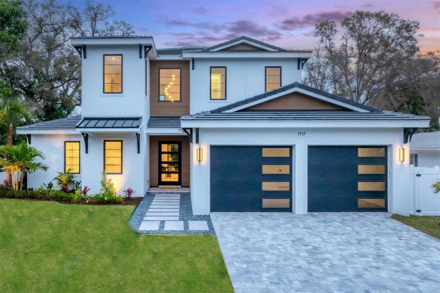 Experience unparalleled luxury and a prime location in this brand new residence. Venture to downtown Sarasota, a vibrant hub of arts, culture, and dining where you’ll find numerous cafes, restaurants, art galleries, theatres, and live music venues. Stroll over to Selby Gardens where you can immerse yourself in nature's beauty, or dine waterfront at Marina Jacks with stunning views of the Sarasota Bay. The location of this home truly offers it all. The residence itself exudes luxury and attention to detail. With high-end finishes and hurricane impact glass throughout, every aspect of this home has been meticulously designed. As you step into the foyer, you are greeted by a grand two-story entryway with a stunning chandelier. The great room features coffered ceilings and floating shelves, adding a touch of elegance to the space. A striking accent wall with a built-in fireplace creates a cozy ambiance for chilly evenings, while also serving as a focal point of the room. The kitchen is open to the great room and boasts Viking appliances, built-in refrigerator, soft close solid wood cabinetry, walk-in custom built pantry, and quartz countertops. Sonos speakers on the first floor assure you can set the ambiance for any occasion. Step outside to the lanai and discover the perfect space for entertaining and relaxation. The heated saltwater pool and spa provide a luxurious oasis for you and your guests to enjoy. Grill up a meal at the outdoor kitchen, equipped with a vented hood, gas built-in grill, refrigerator, sink, and stone countertops or relax by the gas outdoor fire pit. The primary suite, located on the first floor, offers a private retreat with sliding glass doors leading out to the lanai and custom his and hers walk-in closets. The ensuite bathroom features a free standing soaker tub, back lit mirrors and frameless glass shower creating a spa-like atmosphere. Also on the first floor, is a versatile space that can be used as a home office or guest suite, complete with a private bath, custom closet and sliders to the lanai. Upstairs you’ll find three additional bedrooms, each with custom built-in walk-in closets and 2 full bathrooms. The location of the home is unbeatable, with downtown Sarasota, Selby Garden's, Southside Village, the Bayfront, marina, and countless dining options all within close proximity. Gulf Coast beaches and Lido Key are a trolley ride away. Schedule your tour of the property today.