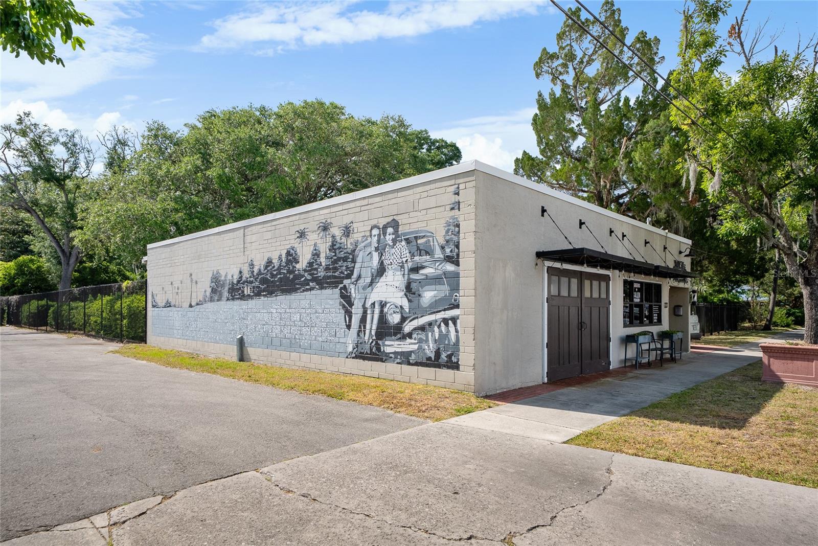 One or more photo(s) has been virtually staged. Bring your business to 910 Warehouse in the heart of the burgeoning Grove Street district of downtown Gainesville with this beautifully finished contemporary office with utilities included. At over 1,000 square feet, the space consists of a large collaborative area with a glass roll up door flooding your work place with natural light and garden views, a private office separated by a stylish glass wall, and an ADA accessible restroom - all with sleek polished concrete floors. A side entrance and parking, as well as street parking, give convenient access to this excellent location situated near Main Street and 8th Avenue. The very walkable neighborhood features several local eateries and many other businesses. A thriving salon shares the building in an adjacent suite. Call today to see the possibilities in a booming part of town!