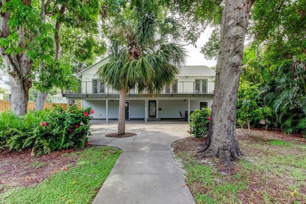 OPPORTUNITY KNOCKING - Downtown Living at Its Finest – No Flood Insurance Required! Discover the perfect blend of comfort, space, and convenience in this meticulously maintained 3-bedroom, 3-bathroom home situated on a sprawling huge lot—offering endless possibilities for expansion. Fully renovated in 2014, this home is thoughtfully elevated above a 4-bay garage, providing ample space for three cars, golf carts, motorcycles, a workshop, a gym, or extra storage. The garage is designed for ultimate functionality, featuring a full bathroom, utility sink, and four rear-alley-access doors for seamless entry. A side parking pad adds extra space for guests, a boat, RV, or additional vehicles. Upstairs, the main living area is bright and open, featuring a modern kitchen that flows effortlessly into the living and dining areas. The primary suite is privately positioned away from the two additional spacious bedrooms. The inside laundry room is already plumbed for two washers and two dryers, offering added convenience. French doors in every bedroom and the living room open onto a large elevated front deck, perfect for enjoying the expansive yard. Below, an equally sized lower deck provides additional outdoor living space for entertaining or relaxing in the Florida sunshine. Additional highlights include:  Impact-rated windows installed in 2023 and impact-rates doors (except garage doors) installed in 2017, Brand-new roof installed June 2025, New split system A/C for the garage in 2023 and Double lot with buildable space for expansion or customization. This unique property offers the rare combination of downtown living with room to grow—don’t miss out on this incredible opportunity!