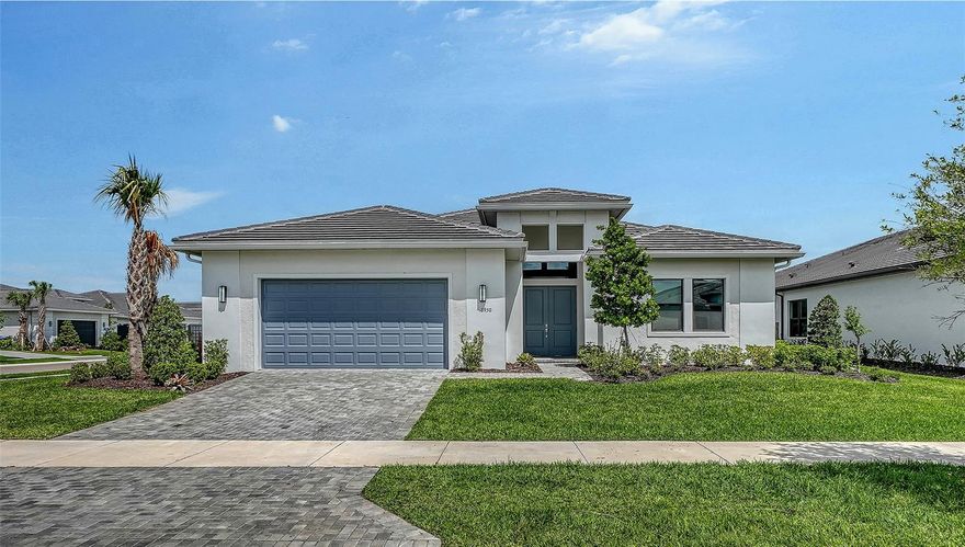 Welcome to this exceptional 2024-built Van Gogh model by Kolter Homes, a rare single-story residence set within the highly sought-after gated community of Artistry Sarasota. Offering 3,066 square feet of thoughtfully designed living space, this 3 bedroom plus office/den, 2.5 bath home embodies a seamless blend of architectural sophistication, modern comfort, and maintenance-free living. A gracious tile-floored foyer sets the tone, welcoming you into an interior defined by clean lines, volume ceilings, and refined finishes throughout. The open-concept layout unfolds into a formal gathering room adorned with custom tray ceilings, flowing effortlessly into a beautifully composed living and dining environment designed for both everyday living and elevated entertaining. Expansive hurricane-impact windows and doors bathe the home in natural light, enhancing the sense of openness while providing peace of mind. At the heart of the home is the gourmet kitchen—anchored by a striking waterfall-edge center island and complemented by abundant counter space, sleek cabinetry, and a substantial walk-in pantry. Outfitted with premium stainless-steel appliances, including a natural gas 30-inch cooktop with vented hood, built-in microwave, thermal wall oven, and dishwasher, this space is designed to inspire both casual meals and culinary pursuits. A breakfast nook offers a relaxed setting for morning coffee, while the adjacent dining area provides an inviting backdrop for more formal gatherings. The private office or den offers a quiet, dedicated workspace ideal for remote work or creative pursuits. The primary suite serves as a serene retreat, featuring coffering ceiling, a sunlit bay window, and a spacious walk-in closet. The spa-inspired bath is thoughtfully appointed with dual vanities and a frameless glass-enclosed oversized shower, creating a calming, refined atmosphere. Two additional guest bedrooms are generously sized and well-positioned, offering comfort and privacy for family or visitors. A well-designed laundry room enhances daily functionality with upgraded cabinetry and a utility sink. Throughout the home, custom motorized window treatments add both convenience and a polished aesthetic, while energy-efficient systems—including open-cell spray foam insulation, high-efficiency HVAC, and a tankless water heater—underscore the home’s modern performance and sustainability. Outdoor living is equally compelling. A custom screened lanai, pre-plumbed for a future summer kitchen, invites effortless indoor-outdoor entertaining. The beautifully newly landscaped, fenced corner lot provides both privacy and space to unwind in a tranquil setting with plenty of room for a pool! Residents of Artistry enjoy access to an array of resort-style amenities, including a state-of-the-art fitness center, lap and resort-style pools, outdoor cabanas, a spa, basketball court, playground, and scenic walking trails set among lush landscaping and serene lakes. Ideally located just minutes from premier shopping, dining, top-rated schools, and Sarasota’s renowned beaches, this residence offers an unparalleled lifestyle opportunity. Move-in ready and meticulously upgraded, this is a rare offering that combines timeless design, modern innovation, and an exceptional Sarasota location.