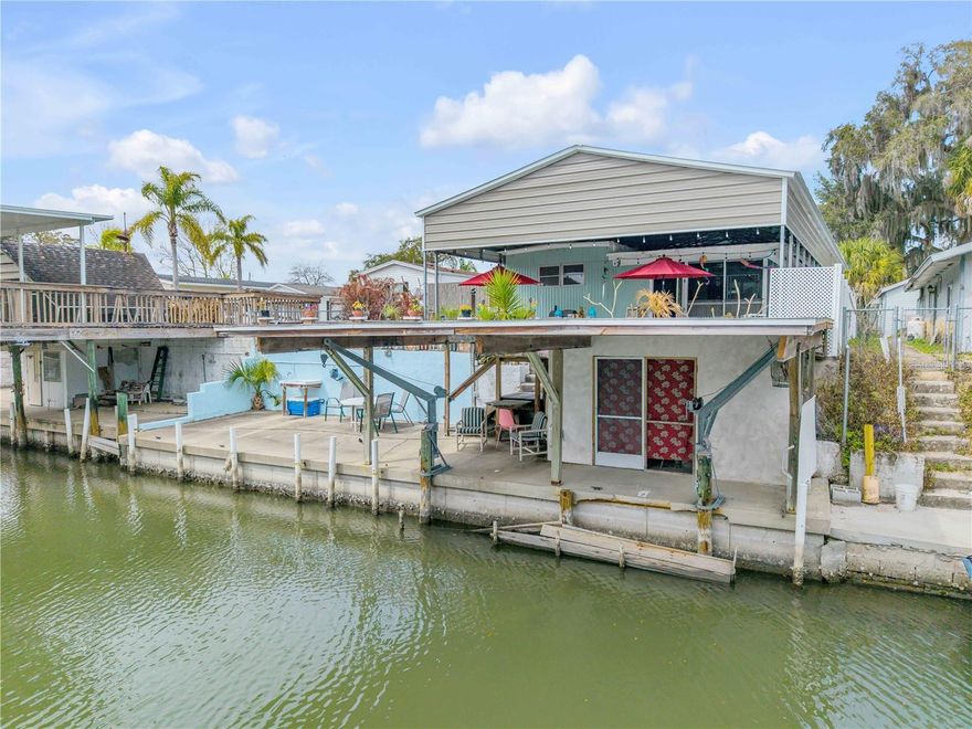 Canal-front living in Indian Harbor Estates offers a relaxed coastal lifestyle with the added flexibility many search for. This property features a main 1120 Sq Ft - 2-bedroom, 2 -bath main home plus a separate Approx. 250 sq ft 1-bedroom, 1-bath in-law suite, creating an ideal setup for extended stays, visiting guests, multi-generational living, or potential income-producing opportunities (buyer to verify local regulations and restrictions). Large laundry room with walk-in storage closet attached by covered breezeway.

Recent updates provide peace of mind, including a Metal roof on the two car garage and guest house, a NEW tankless water heater, a NEW mini-split system, and NEW 200-amp electrical panel in the guest quarters. Gas is available at site for cooking and the home is on public sewer. A full-length engineered metal canopy system, approximately a $30,000 investment, provides structural coverage over the main home, carport for boat dry storage, motorcycles, golf carts, or vehicles adding protection and long-term value.

Inside, the main residence offers a warm and inviting feel with hardwood flooring in main areas and carpet throughout bedroom quarters, a spacious concrete block living room addition, and a primary bedroom featuring a cedar walk-in closet. An ADA ramp provides convenient access to the main home. Outdoor spaces are designed to embrace the waterfront setting, from a brickwork patio and an upper deck overlooking the canal - to the lower sea wall with boat lift and storage shed for all your fishing gear in the boathouse.

Direct access to the ICW. This unique property seamlessly combines incredible waterfront utility with comfortable living. Don’t miss your chance to own a piece of Old Florida charm!