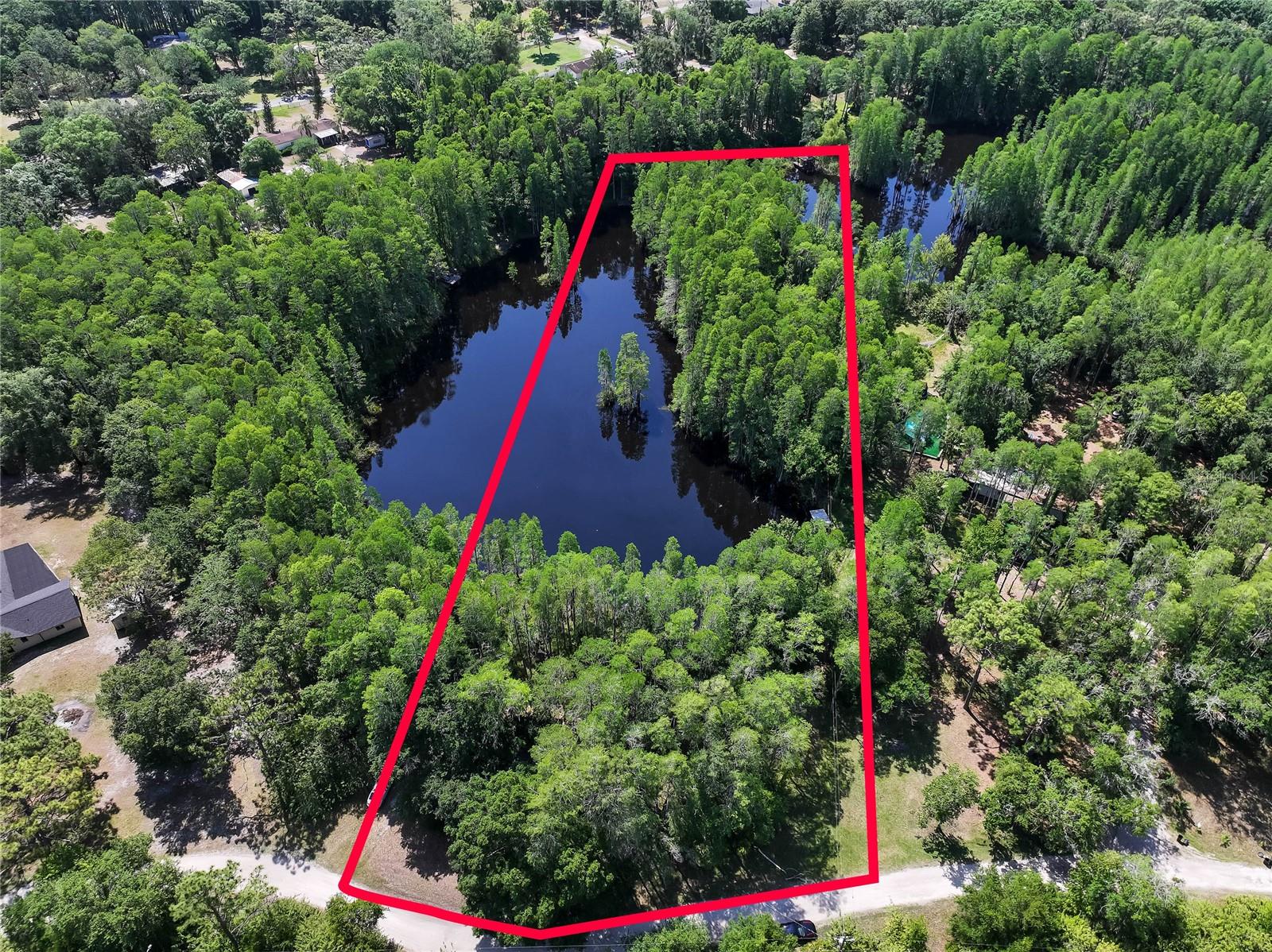 Attention investors and future homeowners! This rare 2.87-acre lakefront lot offers approximately 200 feet of serene water frontage, providing the perfect setting to build your dream home or explore development potential. Set amidst peaceful countryside surroundings, the property includes an existing mobile home with electric, septic, and well already in place—offering a valuable head start for future improvements. Enjoy the best of both worlds: a quiet, rural lifestyle with convenient access to shopping, dining, and everyday amenities, along with an easy commute to Tampa and nearby top-rated schools. With its natural beauty and strategic location, this property is a unique opportunity you don’t want to miss.