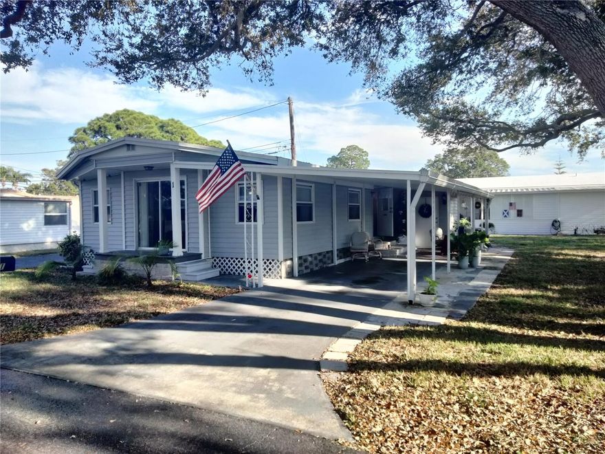 Welcome to the Resident Owned Lake Placid 55+Mobile Home Park in Largo, Florida. Your just minutes from the sugar fine sandy beaches of the Gulf. You can walk to the community lake, which has a concrete seawall and inviting grassy areas to enjoy the lake. HOA dues are only $310 a month (for the 2026 year), and include water, trash, lawn, sewer and cable. One indoor cat is allowed in this park. No dogs allowed, unless they are service or emotional support animals that have proper documentation, and are approved by the board. This home is in a Non-Flood Zone. The home is located on a corner lot, across the street from the clubhouse.

This 1964 built home has been updated over the years, and features 2/3 bedrooms, 1.5 baths, with a small covered front porch area to enjoy your morning coffee. This home was likely a 2 bedroom originally, that is now configured as a 3 bedroom, all with closets. So many things you could do here. The home has a membrane roof over, updated double pane windows with storm shutters. There is a large carport, with attached additional concrete patio. This home has no direct neighbors on either side and is being sold fully furnished (except living room TV).    

The kitchen has been updated with granite slab counter tops and stainless-steel appliances. It has a double stainless-steel sink with updated faucet and waterproof vinyl floors. In addition to this updated kitchen, there is a family room that is currently used as an office. There is carpeting in bedrooms, but otherwise vinyl flooring throughout. It also has updated tile kitchen backsplash. There is a breakfast bar with 3 chairs, updated lighting fixtures, and natural gas stove, and newer on demand hot water heater. Laundry is in the attached shed, which also has storage. The home has window blinds and built-in storage/closets. The full bath has been updated with granite counters on a wood vanity, with tile floors and walk-in shower. 

Canoeing, kayaking, shuffleboard and fishing can all be enjoyed here. There are community events at the clubhouse, where neighbors gather and enjoy. Friendly and walk-able, the downtown Largo area is a great idea for dinner, at one of the areas many restaurants. Check out the local shops, catch a show, take a walk through Largo Central Park, or jump on the Pinellas Bike Trail. Motorcycles not allowed in park. Buyers must be approved by board.

Located in the desirable and quaint Lake Placid M/H Park; a 55+ Resident Owned Community with NO LOT RENT and in a NON-FLOOD ZONE.
