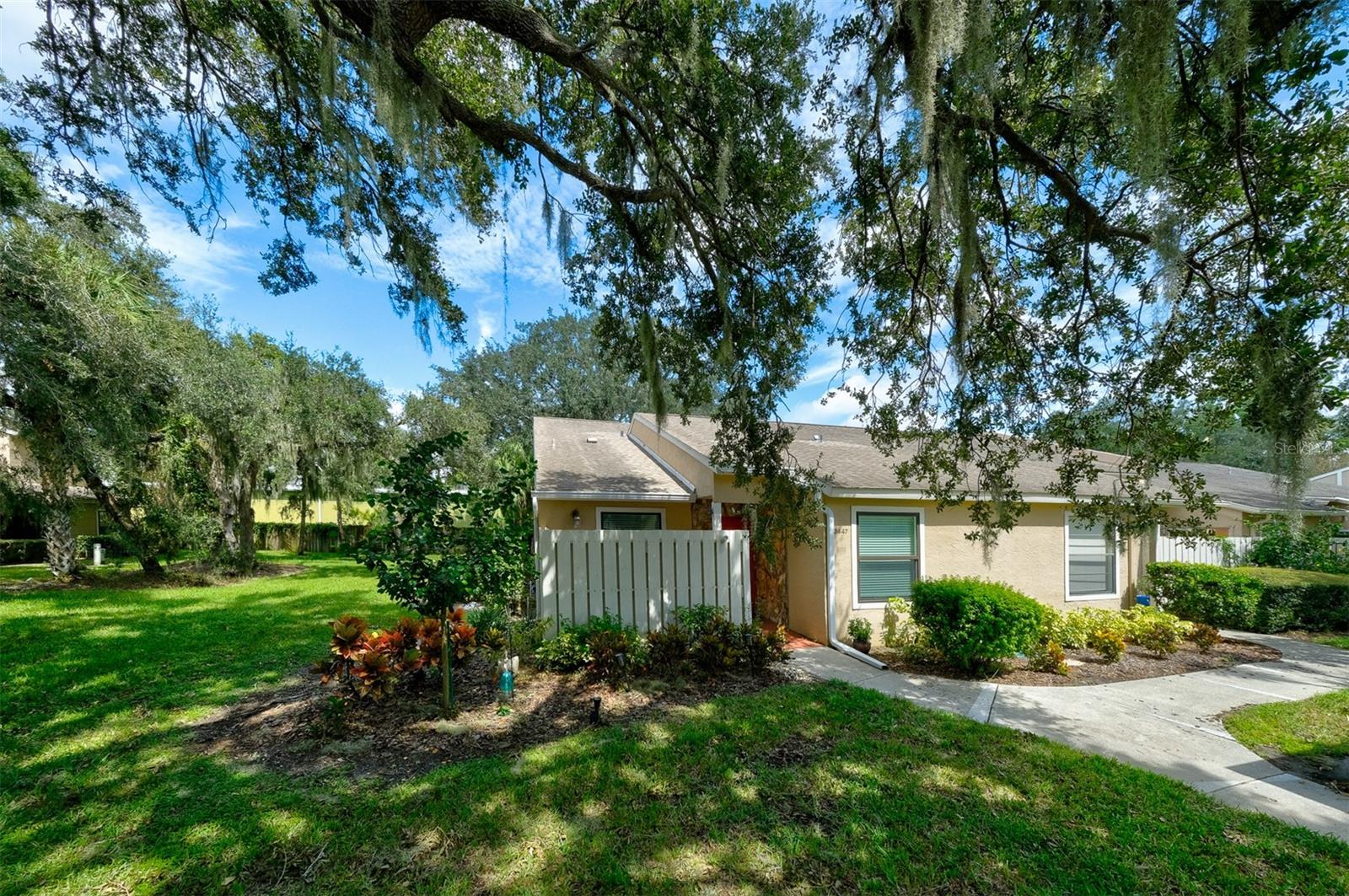This beautifully renovated 3-bedroom, 2-bathroom villa is one of the largest in the Tallywood Condominium Community, offering unparalleled comfort and convenience. Enjoy the ease of main-level living, with a spacious primary bedroom featuring an en suite bathroom located on the first floor. A second bedroom, guest bathroom, and laundry area are also situated on the main level. The second-floor loft boasts a versatile third bedroom, ideal for guests or as a private den or hobby room, with a picturesque view of the park-like surroundings. The kitchen has been recently upgraded with elegant quartz countertops, refaced cabinets, modern appliances, and a large pantry. The charming breakfast nook, bathed in natural light form a large window, is the perfect spot for your morning coffee. Storage will never be an issue with a large attic, under-stairs-storage, and ample closet space throughout. The private carport includes additional storage for seasonal items or beach gear. Situated near the end of a quiet cul-de-sac, this unit offers expansive yard space in the front, side, and back, with minimal traffic. Unwind on the serene open-air front porch or enclosed rear patio, perfect for a relaxing end of your day. This property offers an exceptional location, privacy, convenience, making it ideal for full-time residents, seasonal living, or investors. The 55+ community is rich with amenities and activities designed to foster social connections and enjoyment of the Sarasota lifestyle. Spead over 25 acres of majestic mature oak trees, the community features a heated pool, fenced dog park, fitness center, and clubhouse. You will enjoy living in this tranquil setting that feels miles away from urban life while being only a 3- minute drive to Publix and other shopping and restaurants, 10 minutes from downtown Sarasota, and just 5 minutes more to Lido Beach and vibrant St. Armand's Circle. Experience the best of Sarasota living in this exquisite, move-in ready villa.