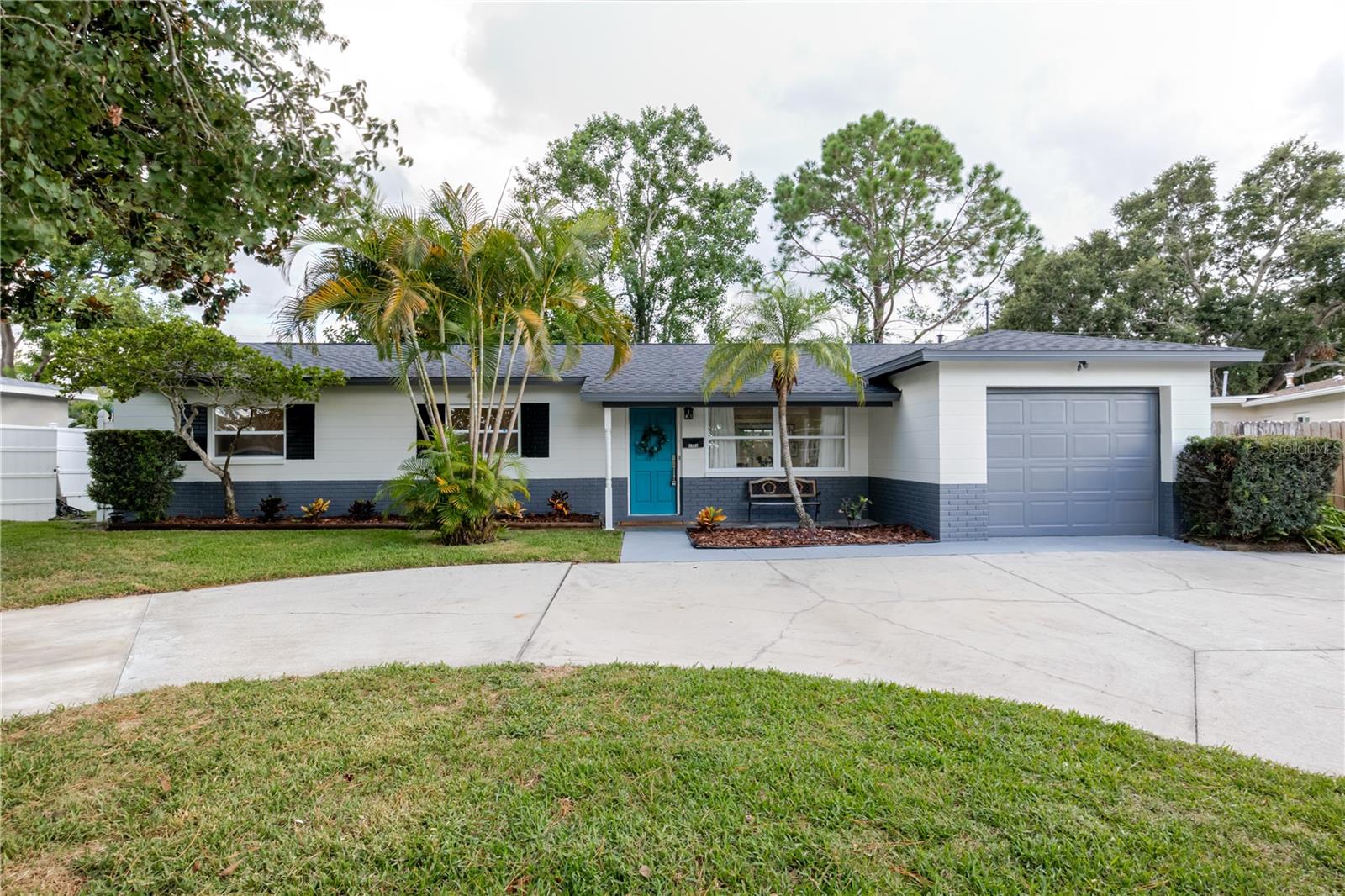 Welcome to this highly sought-after 3-bedroom, 2-bathroom, 1,326 sq ft home located in Disston Heights, St. Petersburg.This home offers peace of mind with a 2025 roof, 2023 AC system, and a newer hot water heater, along with a host of modern updates throughout. The kitchen features contemporary cabinetry, a spacious peninsula, white quartz countertops, and stainless steel appliances, creating a sleek and timeless look. The hall bath includes a modern vanity with quartz countertop, a new toilet, and stylish tile finishes. The primary bath features a pedestal sink, walk-in shower with contemporary tile, and a glass shower enclosure, blending function with modern design. Across the home, you’ll find luxury vinyl plank flooring, fresh interior and exterior paint, new baseboards, and modern trim designs and finishes around the windows, giving every room a polished, updated look. A modern accent wall in the living room adds a stylish focal point and contemporary flair. Additional highlights include a one-car garage with washer/dryer hookups, a screened back porch, a backyard with brand-new sod, and a storage shed in the back corner—perfect for tools, bikes, or outdoor gear. Ideally located just 15 minutes to the beach, 15 minutes to downtown St. Petersburg, and only 6 minutes to Tyrone Square, where you’ll find shopping, dining, entertainment, and everything you need right at your fingertips.