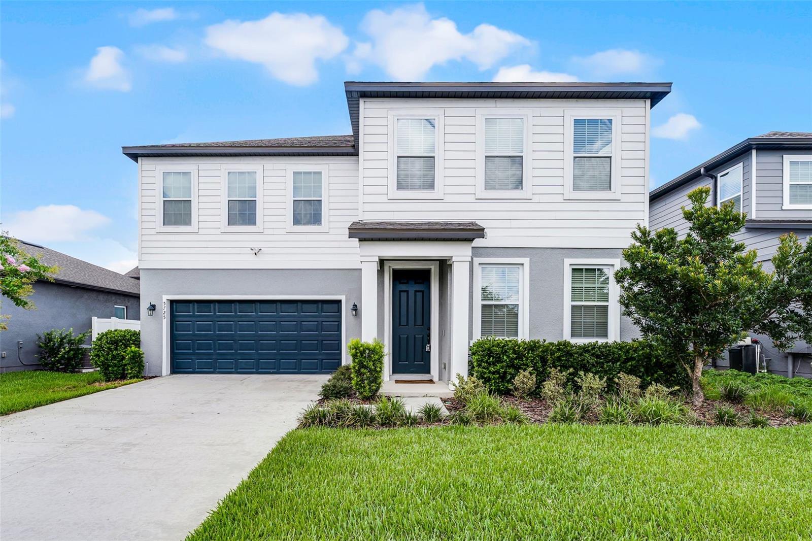 Why wait to build? This stunning 4-bedroom, 3.5-bathroom home with an office/flex room and an oversized 2 car garage is move-in ready and loaded with $70K in upgrades. Wood-look tile flows seamlessly throughout the entire first floor, setting the tone for modern style and easy maintenance. Just off the foyer, double doors open to a versatile office or flex space, followed by a spacious formal dining room with direct access to the butler’s pantry and kitchen. The open-concept kitchen is beautifully appointed with quartz countertops, a subway tile backsplash, shaker cabinetry, stainless steel appliances, and pendant lighting above a large counter-height island with seating. The kitchen opens effortlessly to the expansive living room, where a dramatic two-story ceiling, floor-to-ceiling stone accent wall, electric fireplace, and custom floating shelves create a striking focal point and a warm, inviting atmosphere. A single French door leads to the lanai with an electric screen enclosure and a fully fenced backyard—perfect for indoor-outdoor living. A convenient half bath and under-stair storage complete the first floor. Upstairs, all four bedrooms offer generous space. The primary suite features a ceiling fan, oversized walk-in closet, and a spa-inspired en-suite bath with quartz dual sink vanity and a glass-enclosed shower with rain shower head. One secondary bedroom includes a private en-suite bath, while the remaining two share a third full bathroom. Located in the growing Sunbrooke community, residents enjoy a beautiful resort-style pool, clubhouse, and playground. With new construction still underway in the neighborhood, this home presents an opportunity to skip the wait, enjoy high-end upgrades, and move in right away—all at a price below what it would cost to build new!