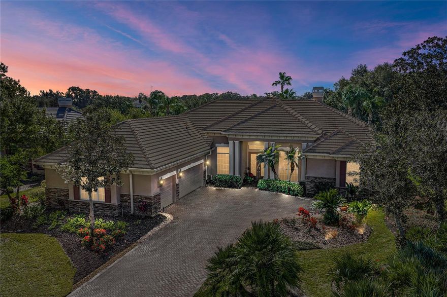 NEW TILE ROOF BEING INSTALLED THIS MONTH!Gracefully positioned within the resort-style and gated Lake Jovita community, on a lush, impeccably landscaped homesite with golf course and water views, this exceptional 3 bedroom, 4 bath residence presents a thoughtfully designed floor plan, refined architectural detail, and an effortless indoor outdoor lifestyle. A 3 car garage, private office, bonus room with sweeping views, and curated outdoor entertaining spaces come together to create a home that feels both warm and welcoming. From the moment you enter, the scale and flexibility of the layout make an immediate impression. Crown molding, tray ceilings, and intricate trim details frame the living spaces, while walls of sliding glass doors flood the home with natural light and capture the surrounding scenery. The formal living room is anchored by a propane fireplace and offers elegant sightlines across the formal dining room, through triple sliders to the pool, and into the eat in kitchen through decorative pillar accents, creating a sense of cohesion and flow throughout the main living areas. The kitchen is beautifully appointed with granite countertops, a substantial center island with generous seating, stainless steel appliances, a custom range hood, and a walk in pantry. Centrally located, the oversized family room is ideal for entertaining on any scale, with sliding doors intentionally placed to connect seamlessly to the outdoor living spaces beyond. A flexible bonus room enjoys stunning golf course views and sits just off a full guest bath, offering effortless pool access and versatility for guests, media, or additional living space. Near the front of the home, a private office features wood flooring and detailed ceiling work, providing a polished work from home retreat. The primary suite is privately positioned and designed as a true sanctuary, complete with tranquil views, a gracious foyer entry, two walk in closets, and an impeccable ensuite bath. This spa inspired space features a central island, dual vanities with seating, a jetted bathtub, and a walk in shower. Bedroom 2 is thoughtfully placed on the opposite side of the home near a hallway desk nook and offers a walk in closet and ensuite bath, while the 3rd bedroom provides a generous closet and convenient access to the home’s 4th full bathroom. Additional functional space includes a temperature controlled private garage office, ideal for those seeking a dedicated workspace without compromising storage. Outdoors, peaceful Florida living awaits with stone accented gathering areas surrounding a built in propane fireplace and grill, a second covered seating space, and a serene pool and spa overlooking the golf course from the screened and pavered lanai. Notable extras include surround sound wiring, central vacuum with floor sweeps, a water softener, and a brand new roof with a full price offer. Residents of Lake Jovita enjoy access to a playground, park, pickleball court, and walking trails. Optional membership packages at the Lake Jovita Golf and Country Club include access to 2 18- hole world-class golf courses, a Jr. Olympic size swimming pool, a restaurant, a clubhouse, a fitness center, a pro shop, and more! Make this holiday one to remember by finding your dream home in one of the most desirable communities. Schedule your private showing and experience the elevated living Lake Jovita is known for.