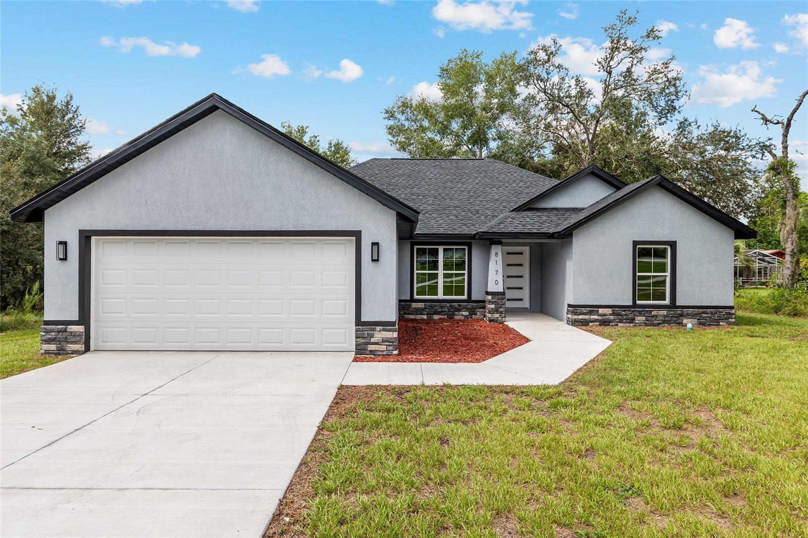 COMPLETED AND MOVE-IN READY! SELLER WILL PAY UP TO 10K TOWARDS BUYERS CLOSING when using preferred lender. Be the first to own this beautiful brand-new home in the desirable community of Citrus Springs—with no HOA and on a CORNER LOT! Designed with modern living in mind, this home features a spacious open floor plan and a split-bedroom layout for added privacy. Inside, you’ll find three bedrooms and two bathrooms, including a generously sized master suite with a walk-in closet and a luxurious en suite bathroom complete with a relaxing soaking tub and separate shower. The open-concept kitchen and living area are perfect for entertaining, and feature stylish quartz countertops. Enjoy the convenience of an indoor laundry room and step outside to a large covered back porch—ideal for relaxing or hosting family and friends. Don’t miss your chance to own a brand-new home with quality finishes in a peaceful setting. Schedule your tour today!
