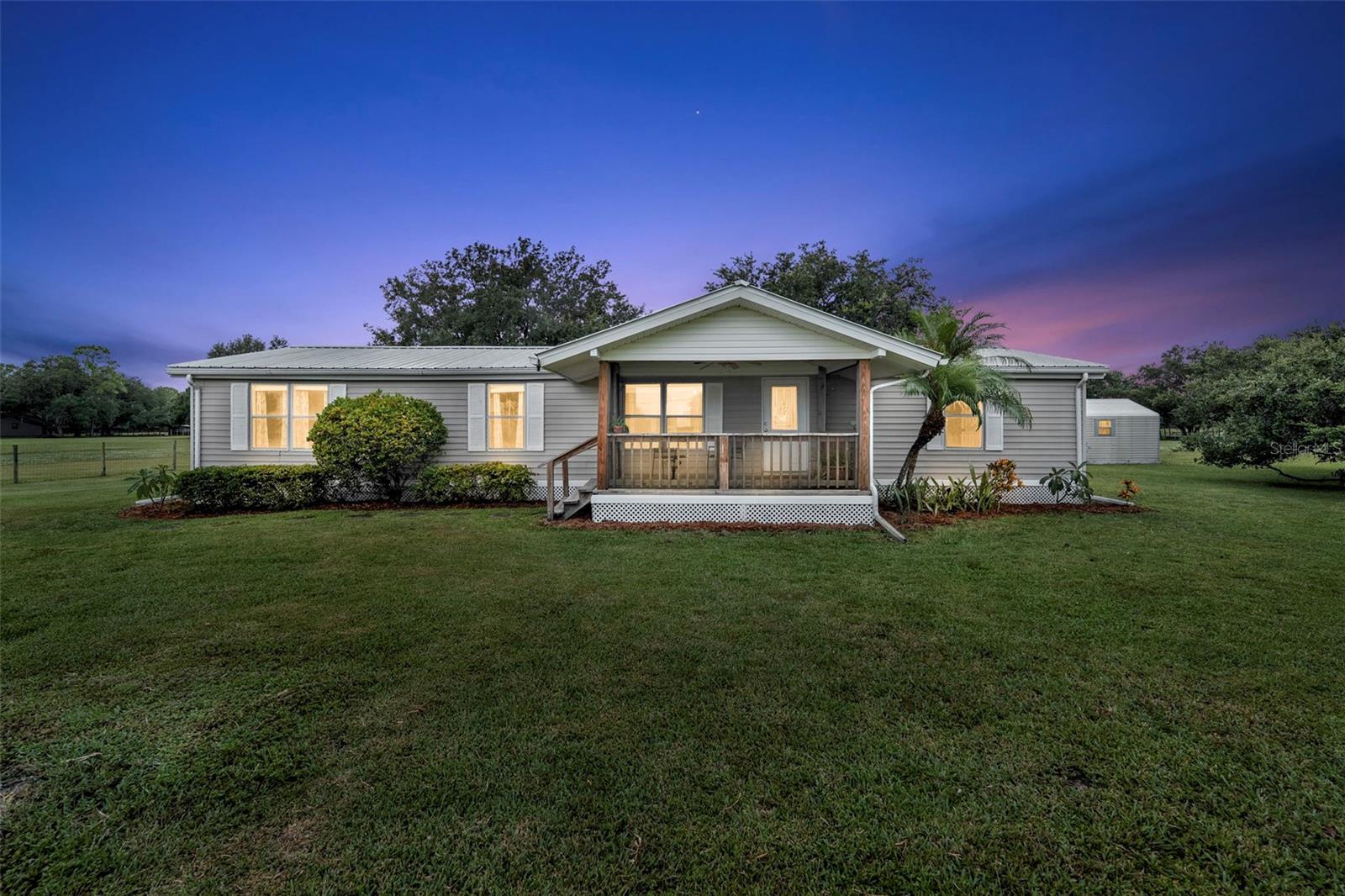Set on over 10 sprawling acres, this 4-bedroom, 3-bath property offers a rare opportunity to own a piece of peaceful countryside in one of LaBelle’s most desirable rural settings. Surrounded by mature oak trees and wide-open pasture, this mostly cleared land provides space, privacy, and flexibility for a variety of lifestyles—from hobby farming and equestrian use to simply enjoying the serenity of nature.
The home itself is a spacious and functional mobile residence with an open porch, ideal for quiet mornings or evenings spent soaking in the scenic surroundings. Inside, the layout accommodates comfortable living with four bedrooms, making it a great option for families, multi-generational living, or those needing flexible space for a home office or guest rooms. New A/C units ensure year-round comfort.
The entire property is fenced and cross-fenced, ready for livestock, horses, or large outdoor projects. Existing structures include a barn, a shed for tools or equipment, and a chicken coop—offering immediate functionality for those ready to embrace country living. Whether you're looking to raise animals, grow a garden, or expand your agricultural setup, the land provides ample room to bring your vision to life.
In addition to this well-equipped property, the adjoining parcel is also available for sale under MLS# 2025002781, offering even more potential to grow your estate. Located only about five minutes from downtown LaBelle and with easy access to SR-80, you’ll enjoy both seclusion and convenience. The nearby Caloosahatchee River provides the perfect setting for boating, fishing, and outdoor recreation. This is a rare find that blends rural charm with everyday accessibility—perfect for those looking to escape the hustle without sacrificing connection. A true slice of Florida country life, this property delivers incredible value and endless potential.