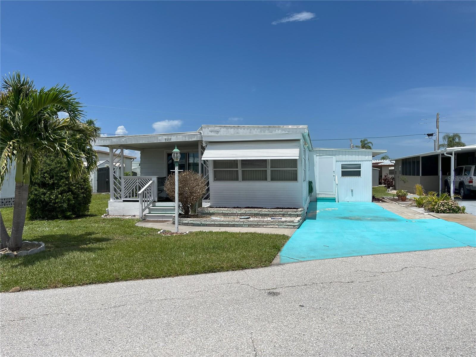 Located on a desirable lot and a half, this 2 bedroom, 2 bath home offers extra outdoor space and room to spread out—something rarely found in Trailer Estates. A welcoming front porch opens into a spacious living room that flows into the dining area and kitchen, creating a comfortable and connected main living space.
The primary bedroom features dual closets and direct access to an ensuite bathroom that conveniently doubles as the laundry room. The second bedroom includes a walk-in closet for generous storage. With an inside utility room, this home offers functionality and convenience along with its unbeatable location.
Located in Trailer Estates, a Special Park and Recreation District governed under Chapter 418, Florida Statutes, residents own their land—no lot rent, CDD, or HOA fees. The annual park tax covers cable, high-speed internet, trash pickup, fire and rescue services, and access to outstanding amenities including a marina with rentable boat slips, private beach, pool, hot tub, fitness center, shuffleboard, bocce ball, pickleball, woodshop, and nearly 60 active clubs and social events. Experience one of Sarasota Bay’s most vibrant and welcoming 55+ communities.